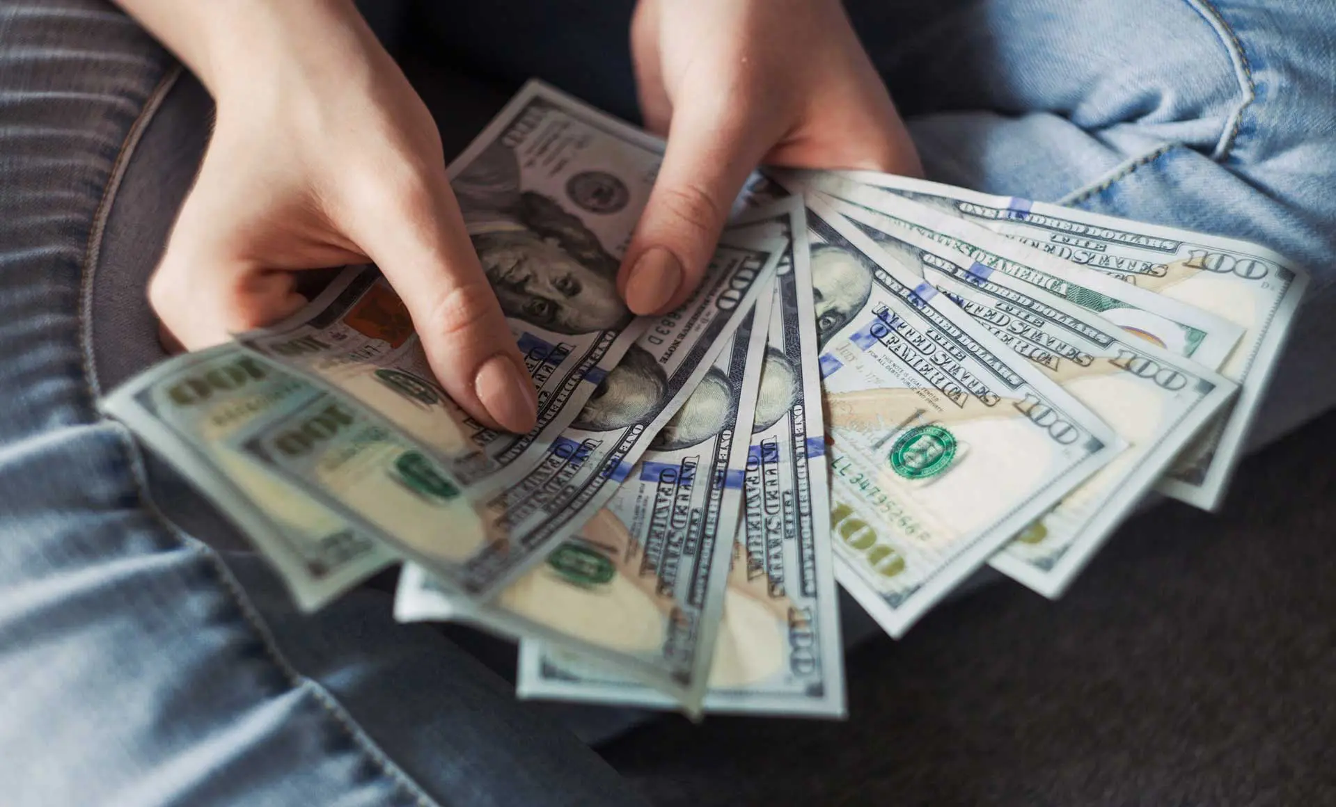 A person holding american money