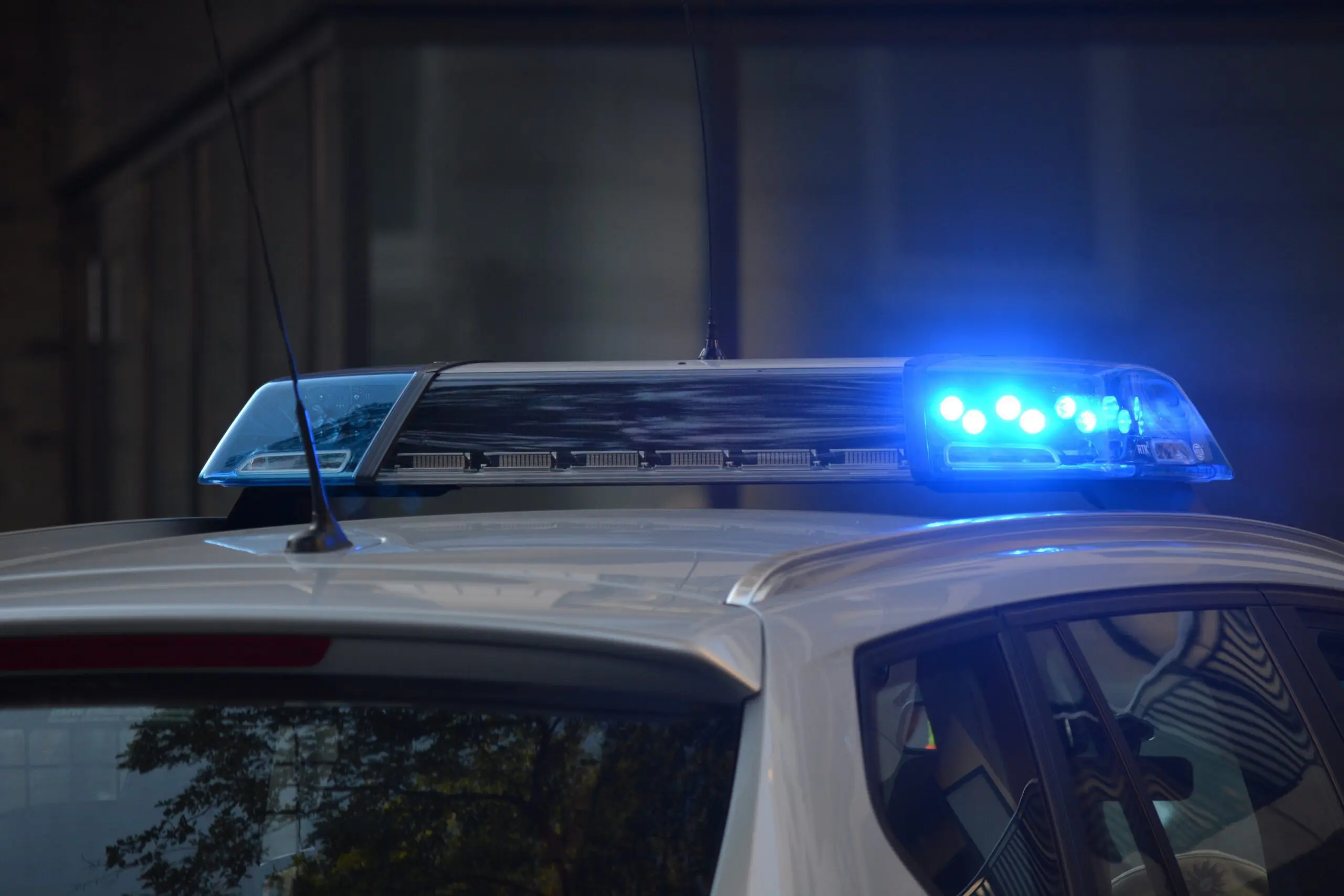 The top of a police car, with the blue light active