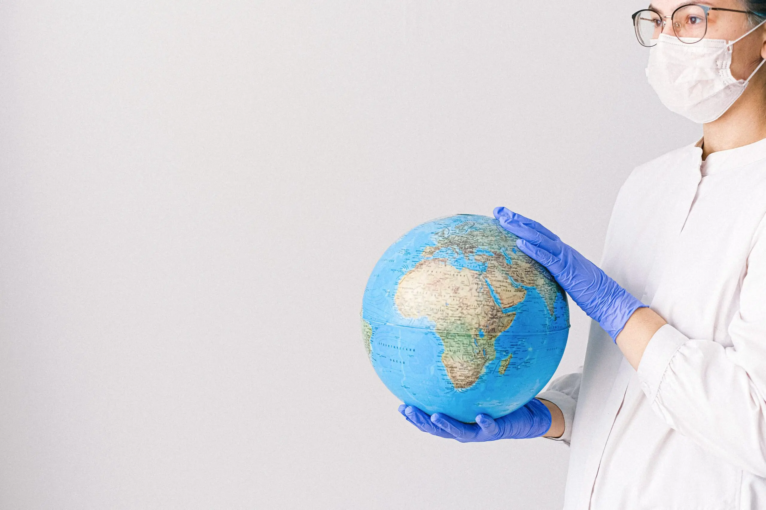 Someone in ppe holding a globe