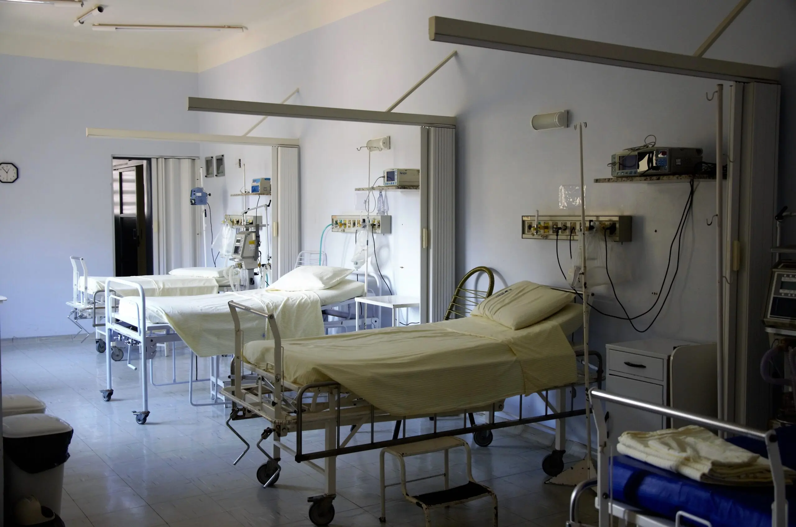 A hospital ward, containing empty beds