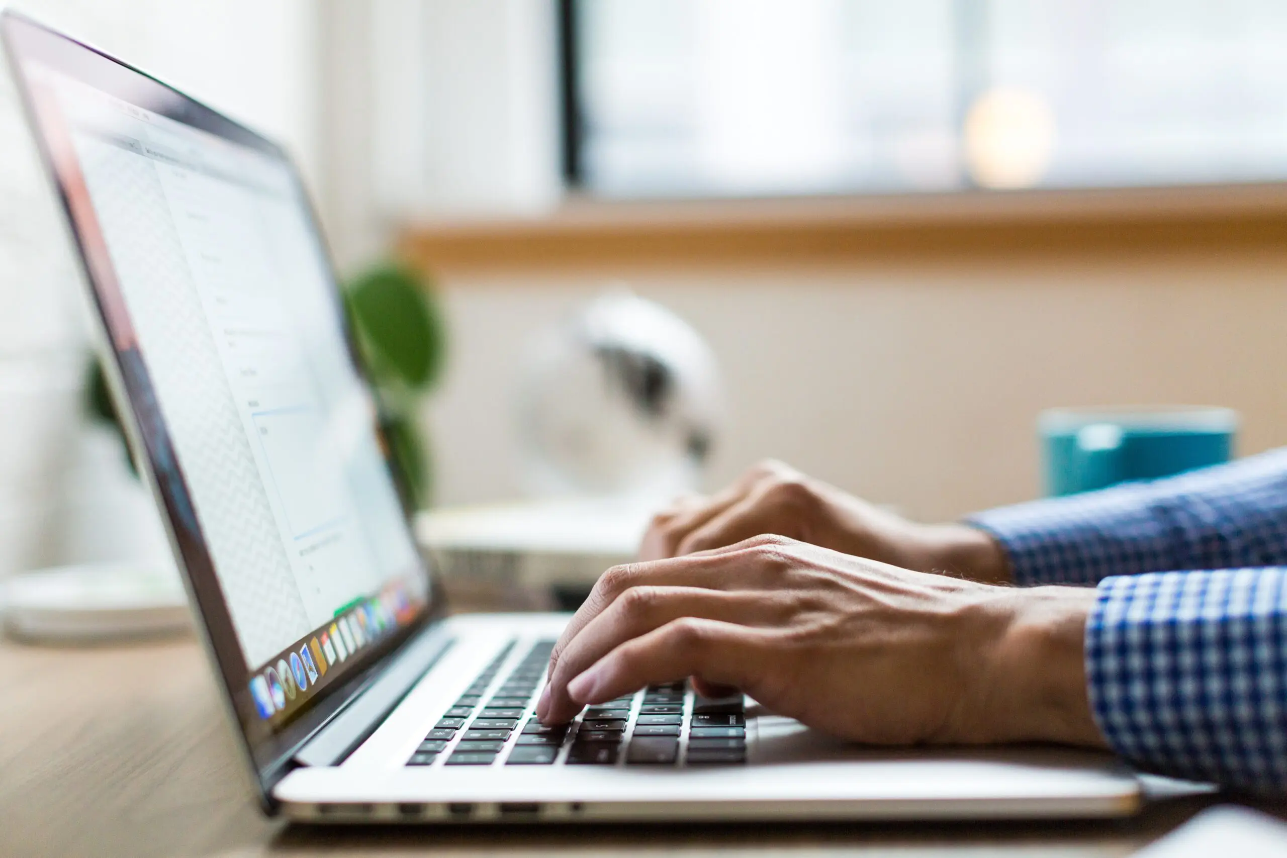 An image of someone typing on a laptop