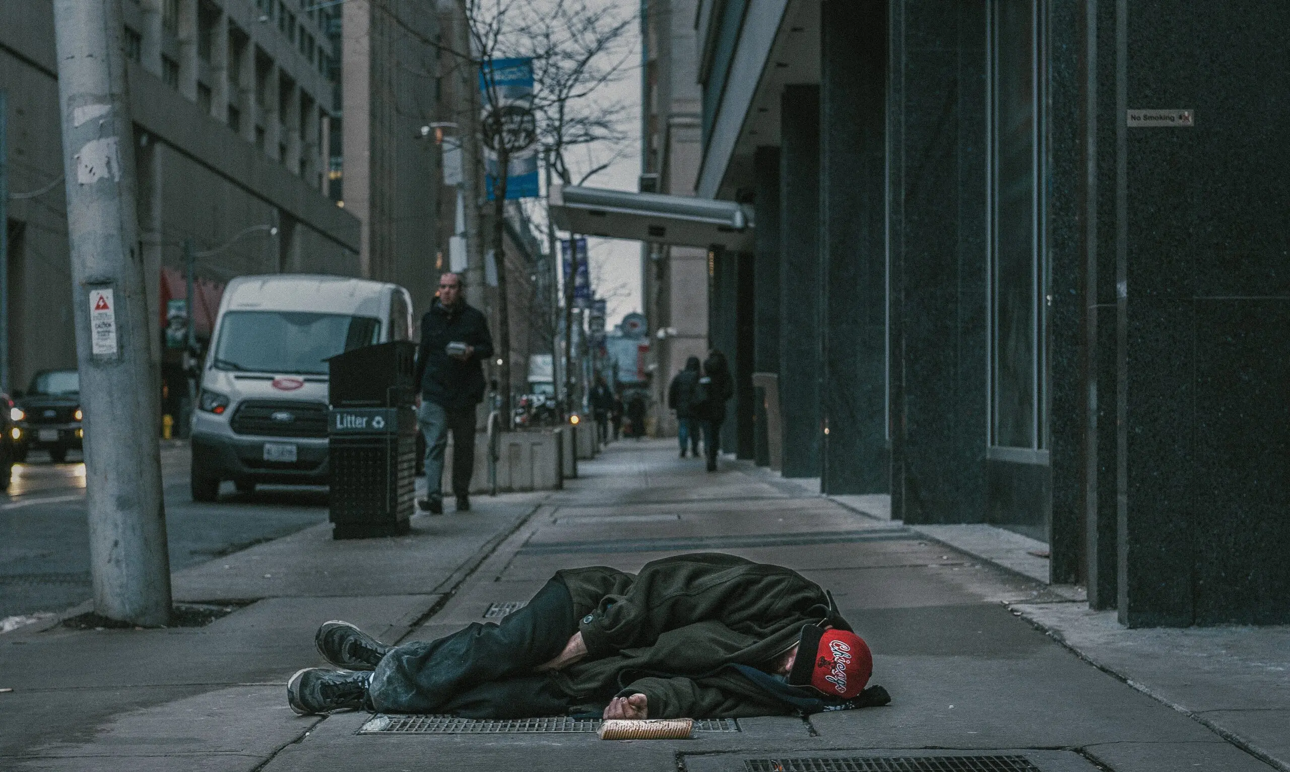 A person lying in the middle of the street