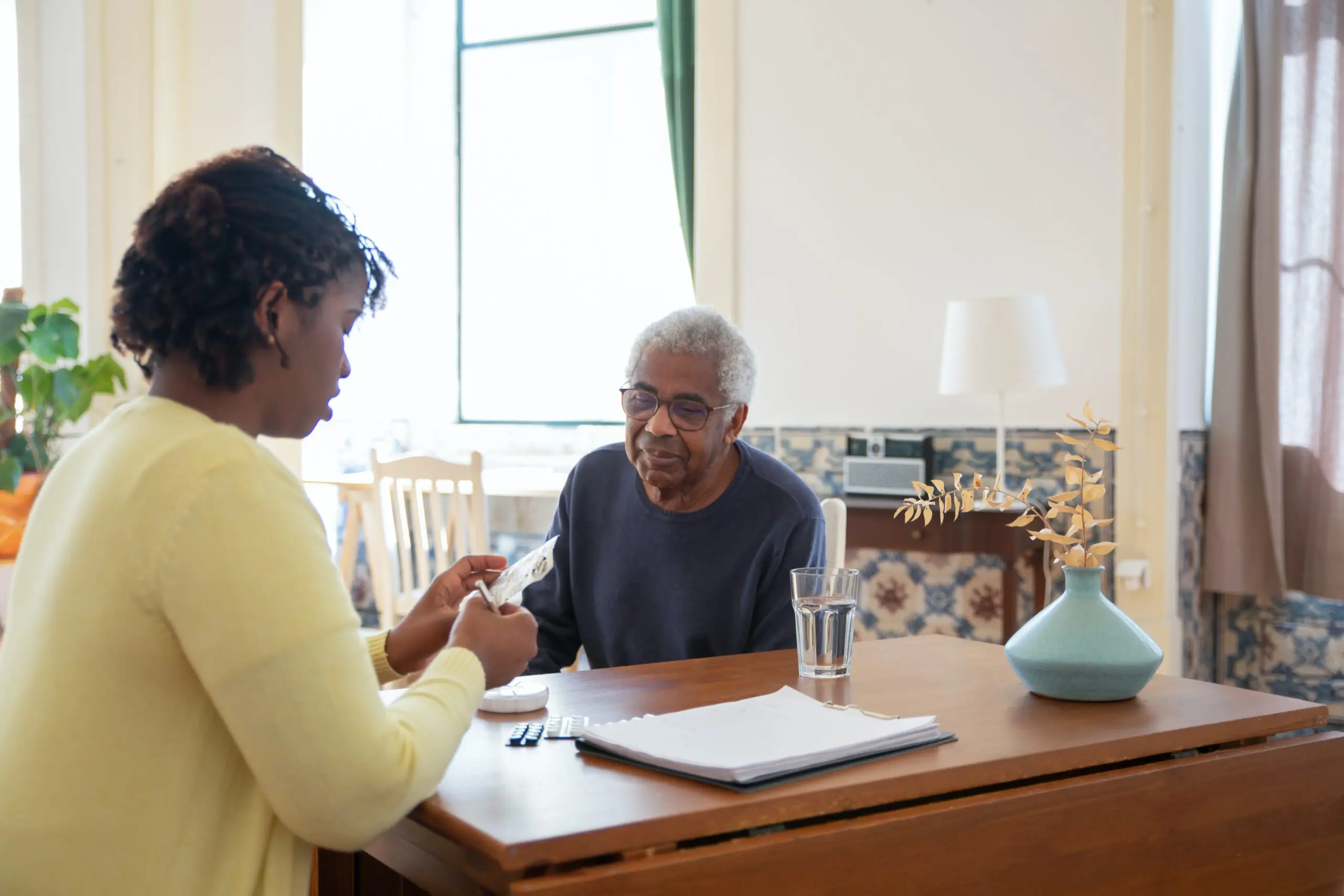 Two people talking to each other over a desk