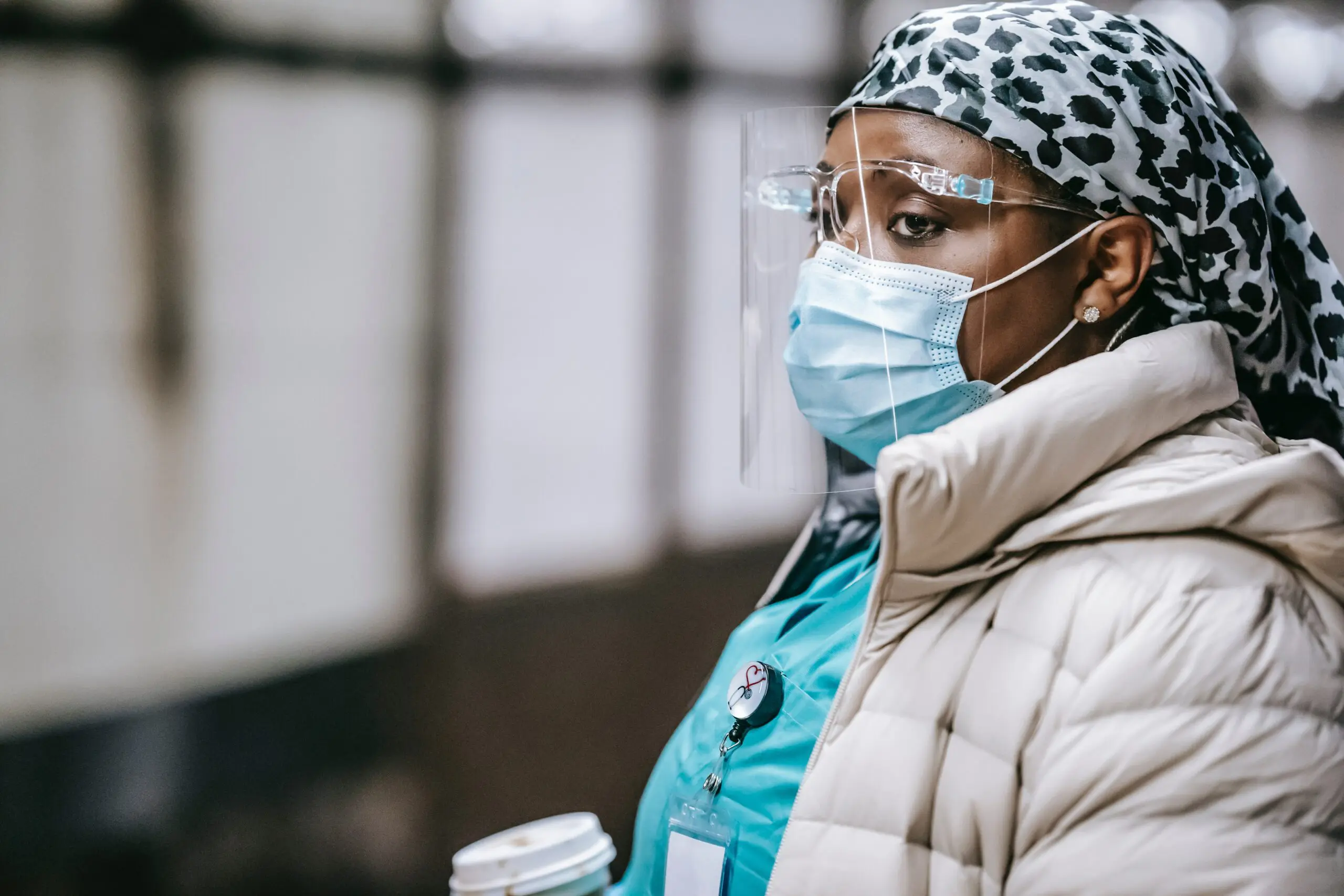 Person in coat wearing PPE