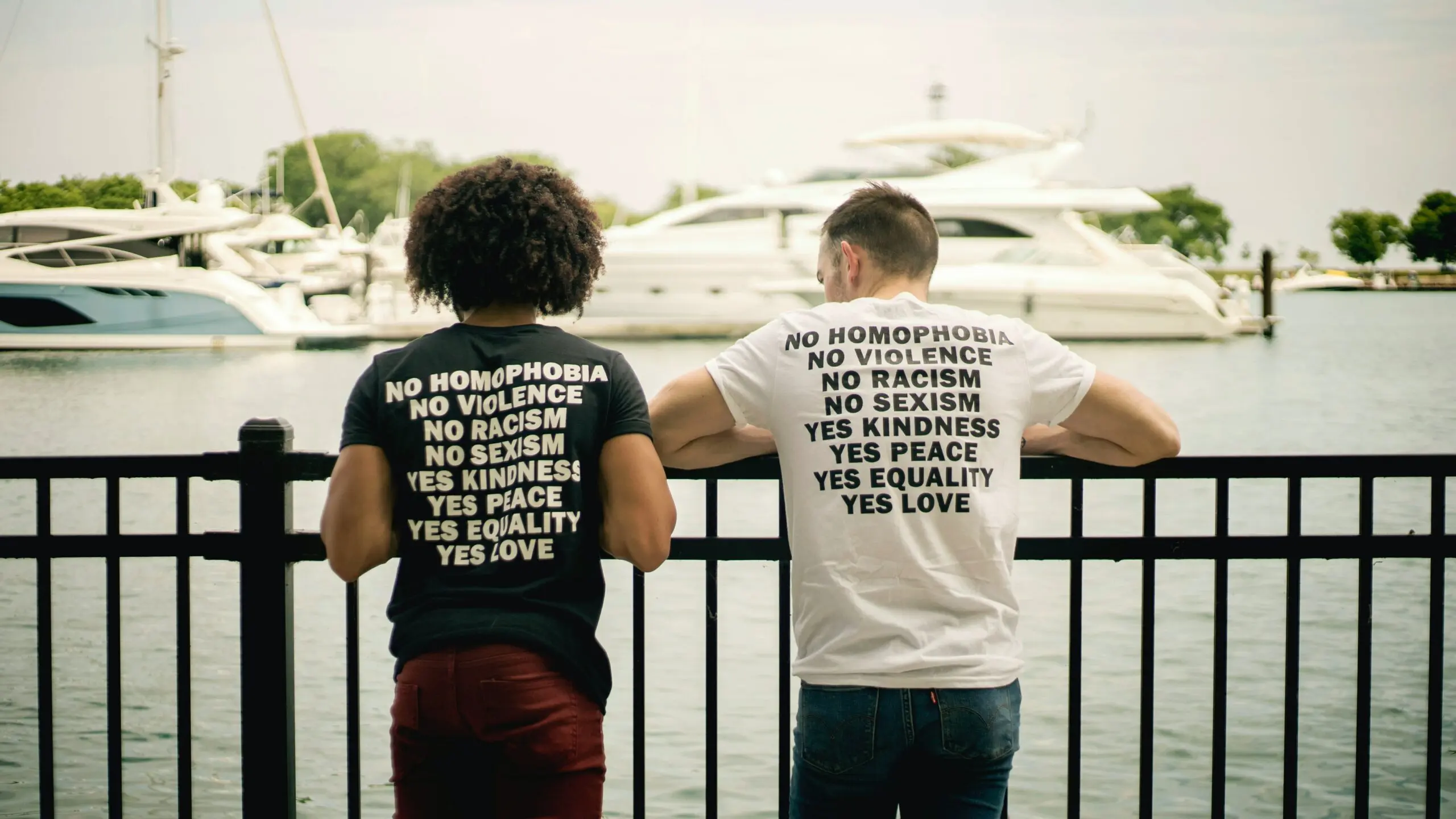Two people wearing anti-bigotry t-shirts