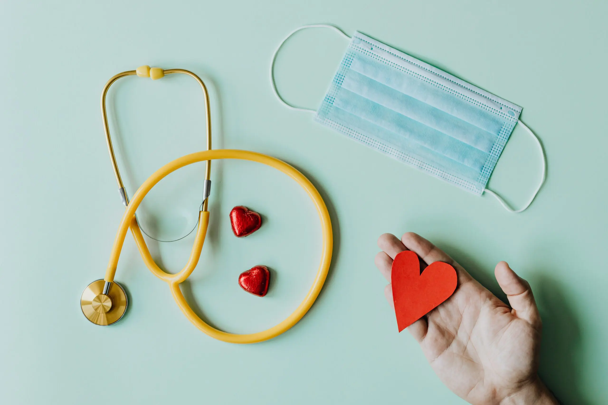 A stethoscope, a mask, and three hearts