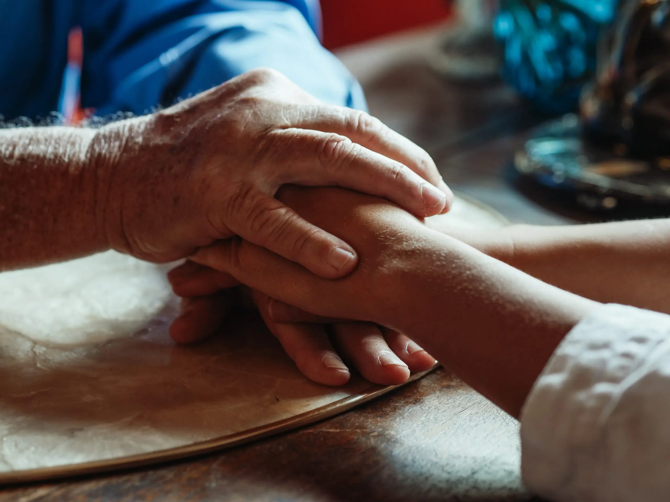 Two people holding hands with each other