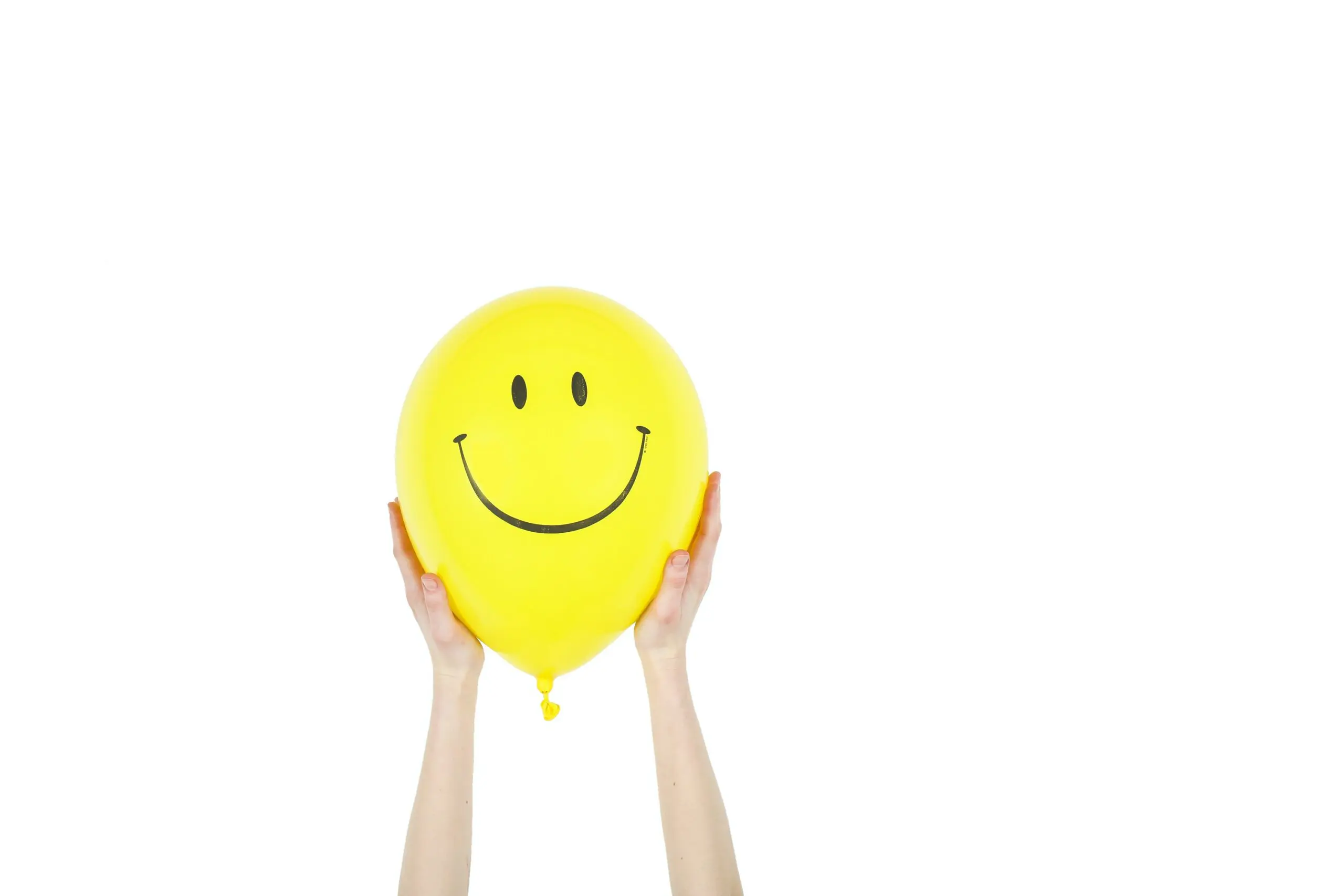 A yellow balloon with a smiley face on it