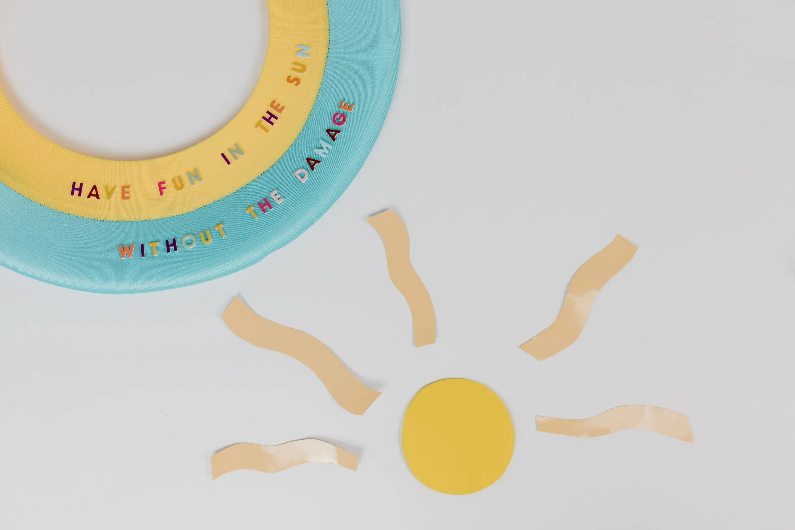 A stylised sun, next to the words 'Have fun in the sun without the damage'