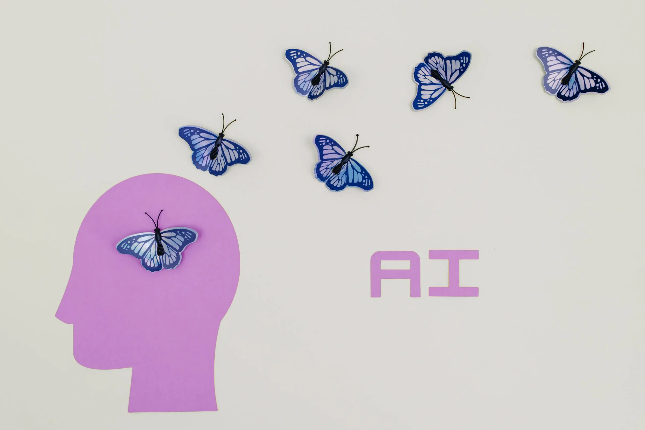 The letters A I, a stylised head, and six butterflies