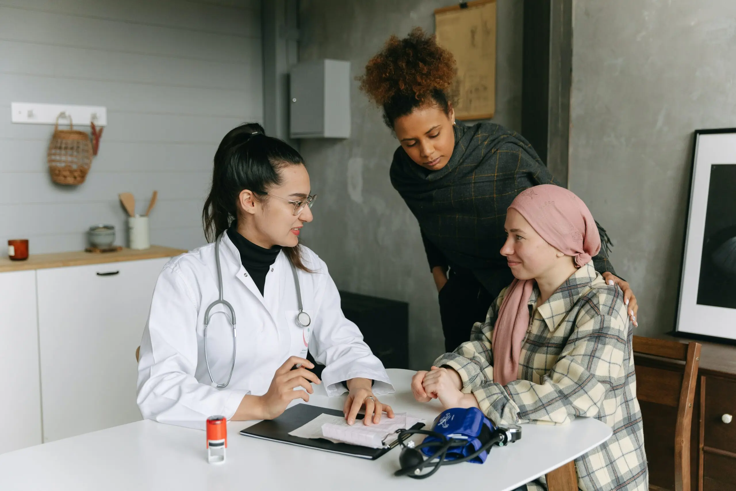 Three people talking around a table