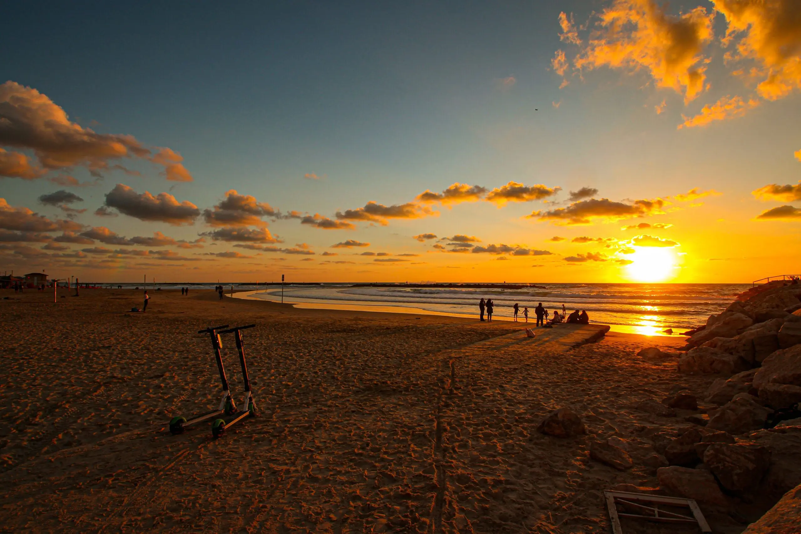 A beach scene, with a setting sun