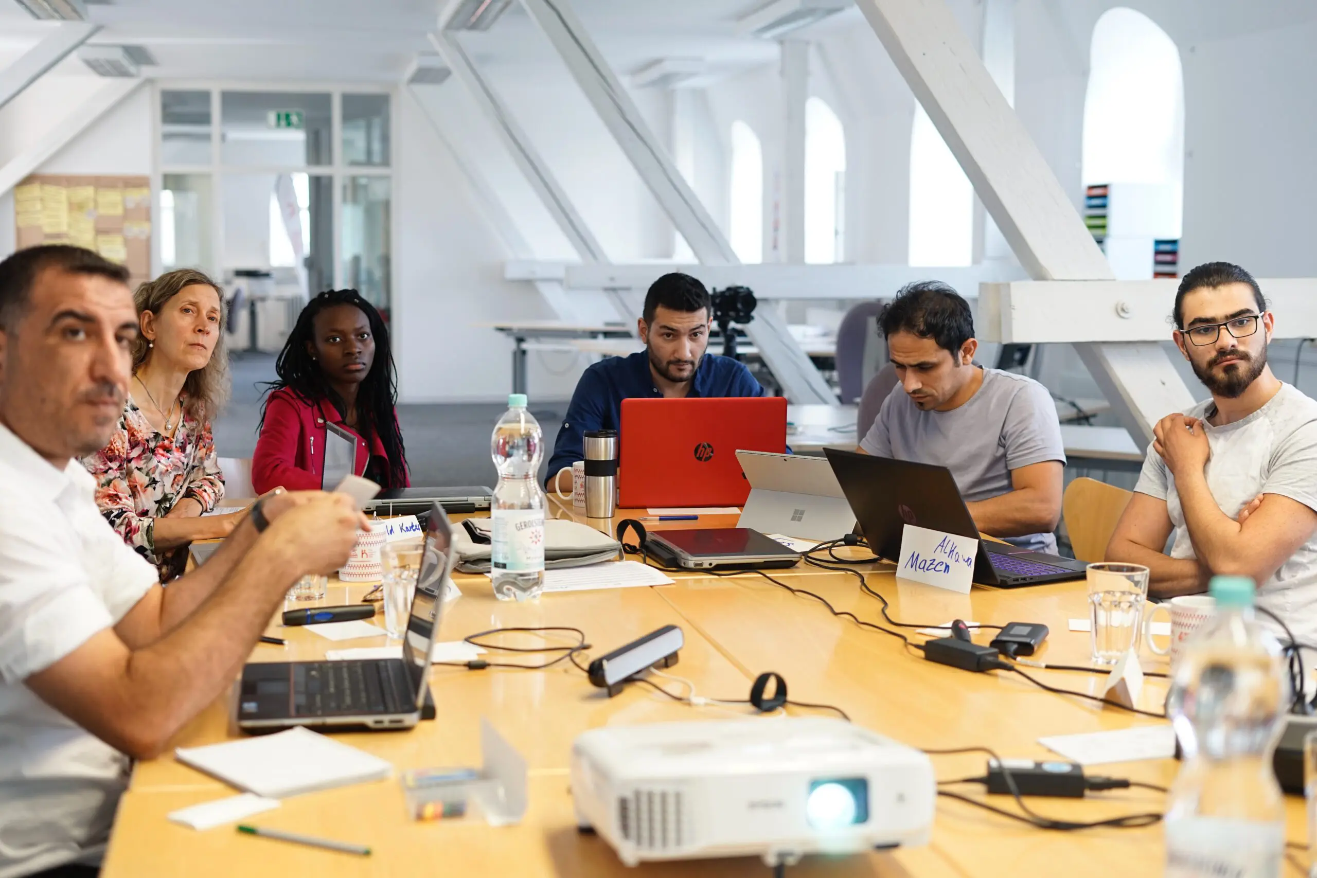 A meeting, with everyone looking at a presentation