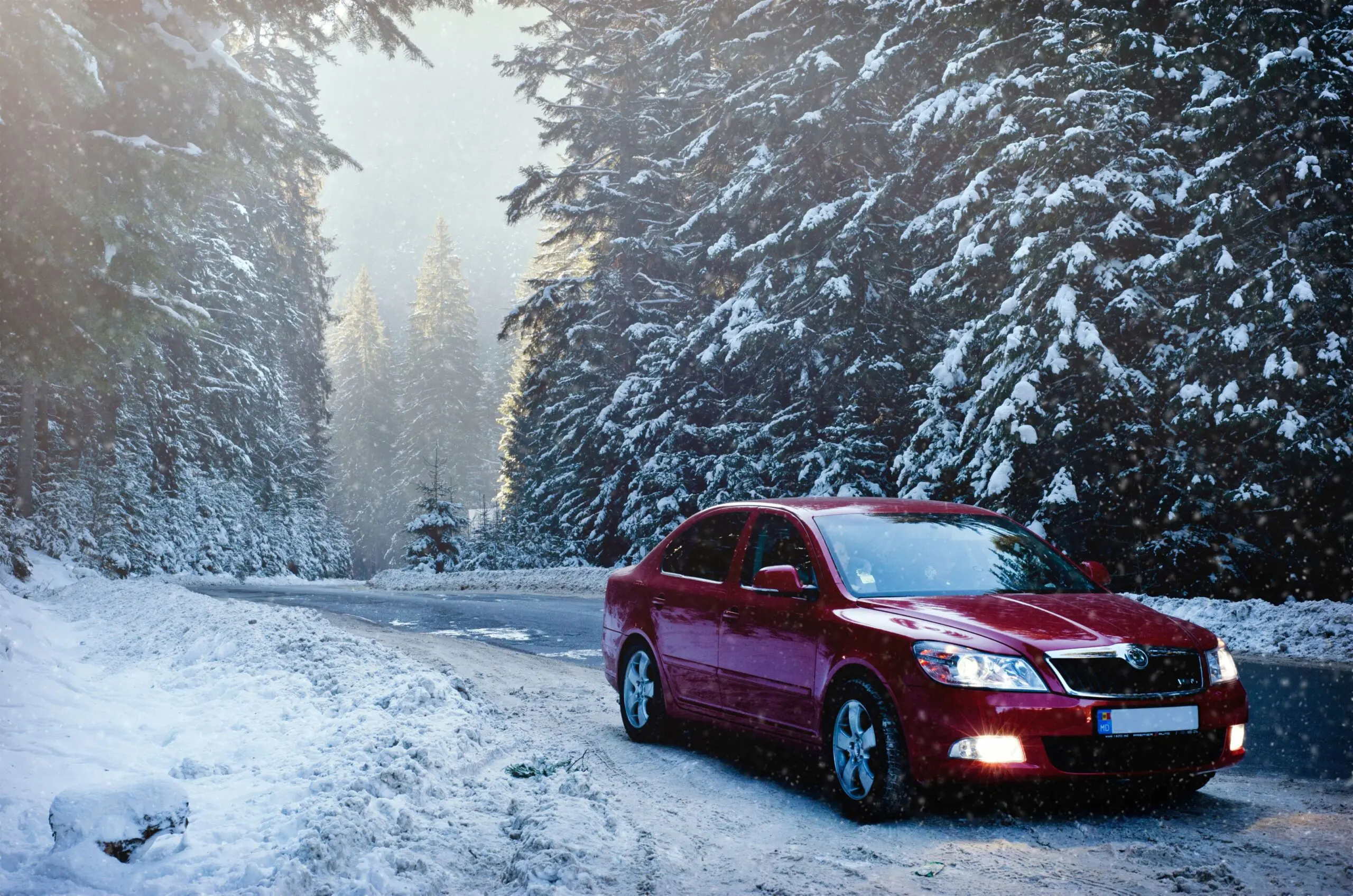 A car driving down a road in the snow