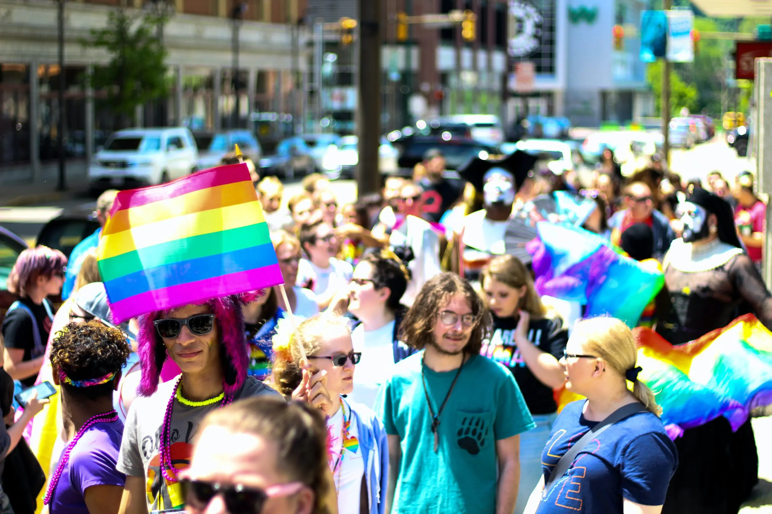A pride parade, with many people and rainbow flags