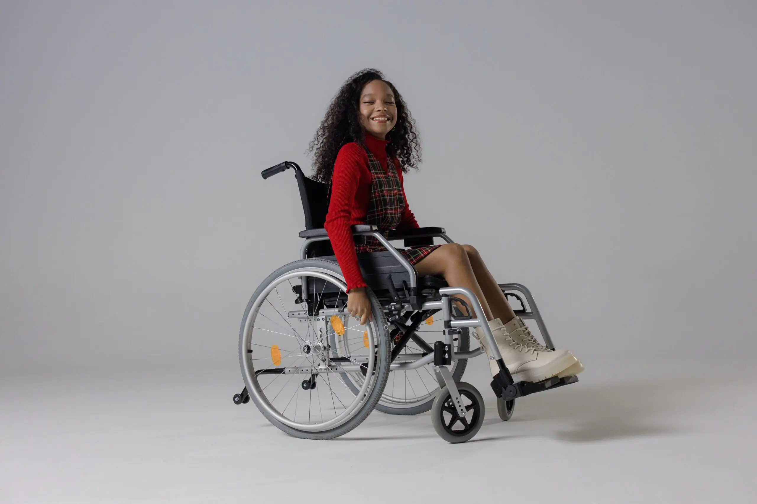 Someone in a wheelchair smiling at the camera