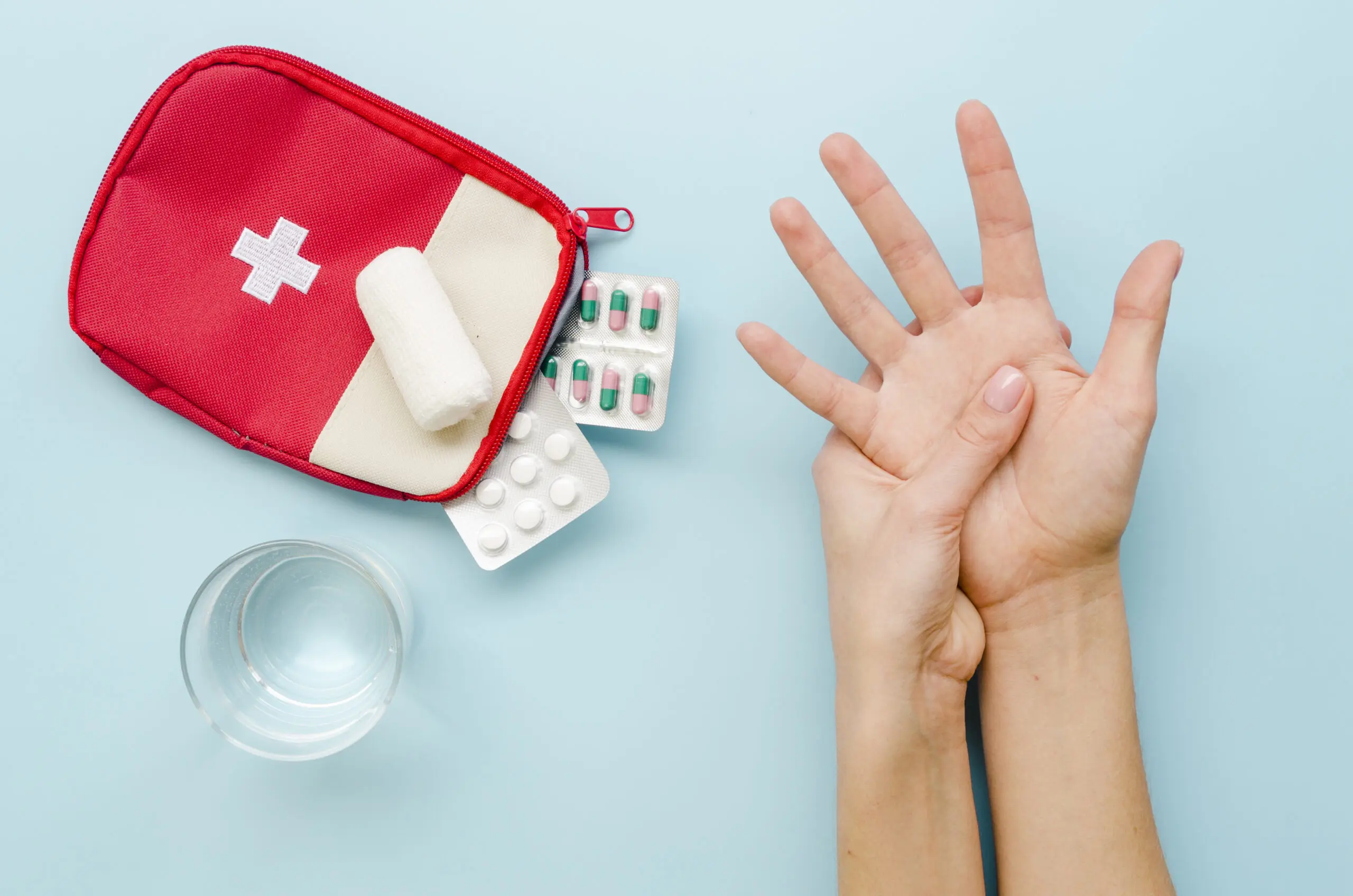 A first aid kit by a pair of hands