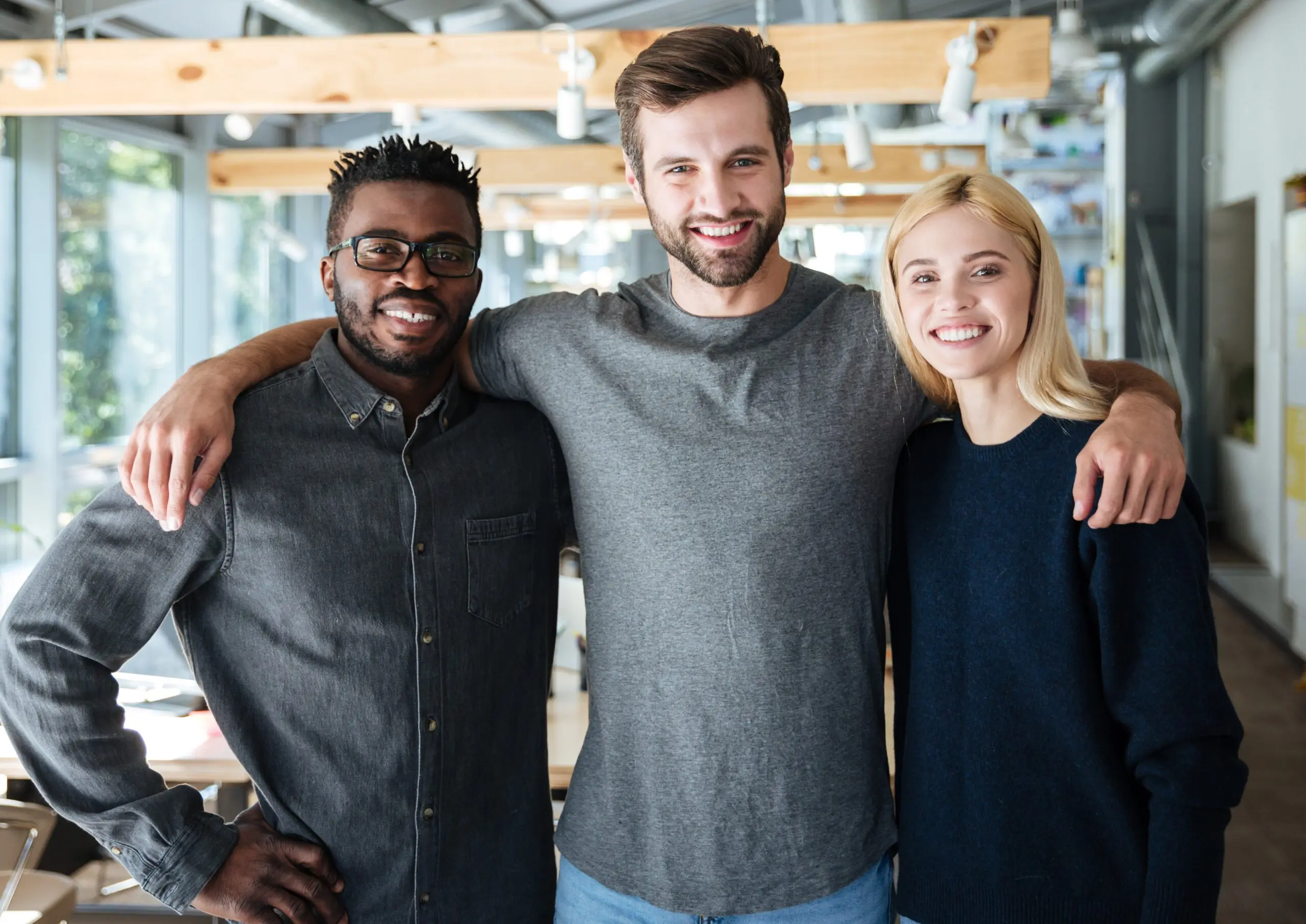Smiling colleagues in the workplace looking at the camera