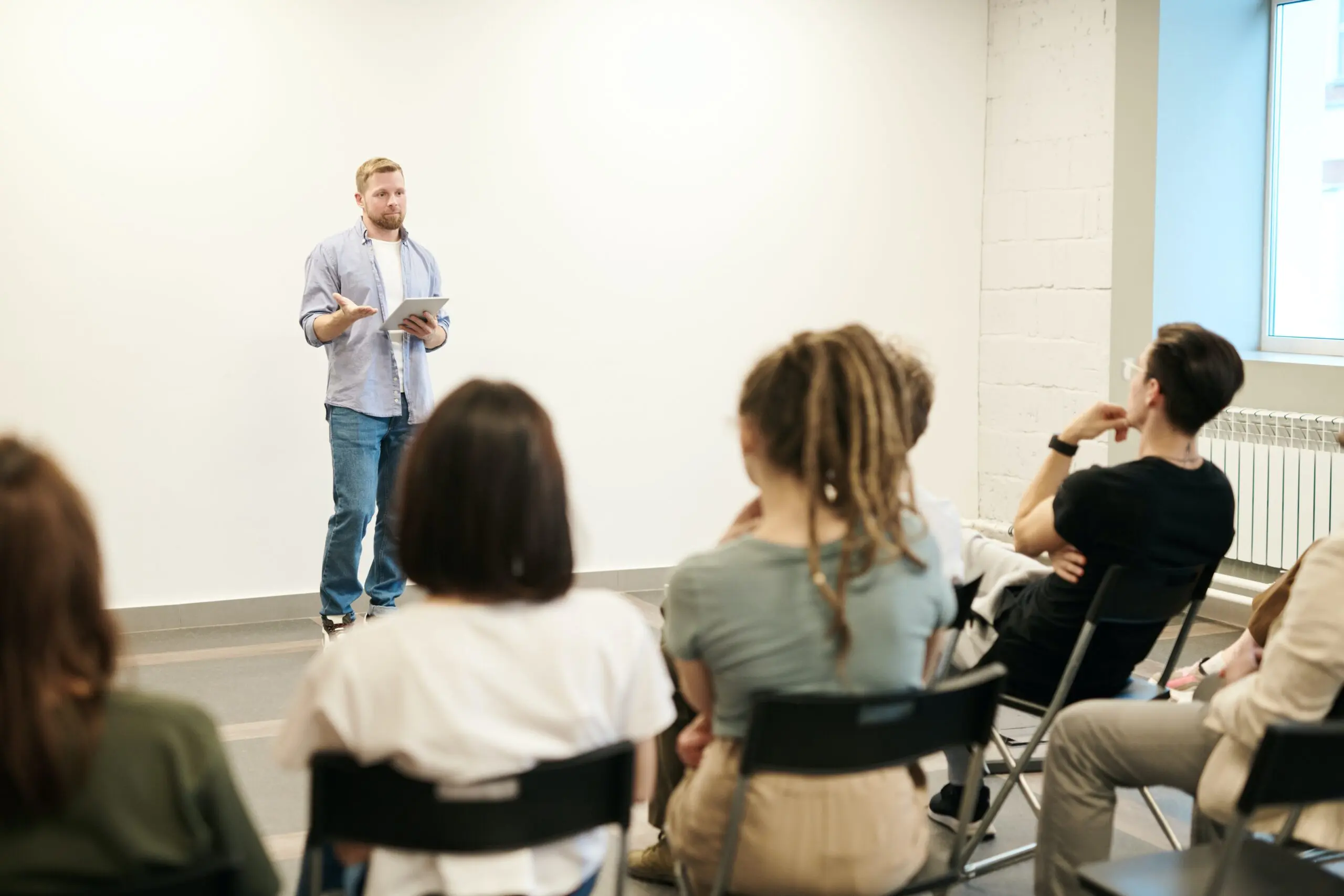 staff-team-engaged-in-training-being-presented-by-a-care-professional