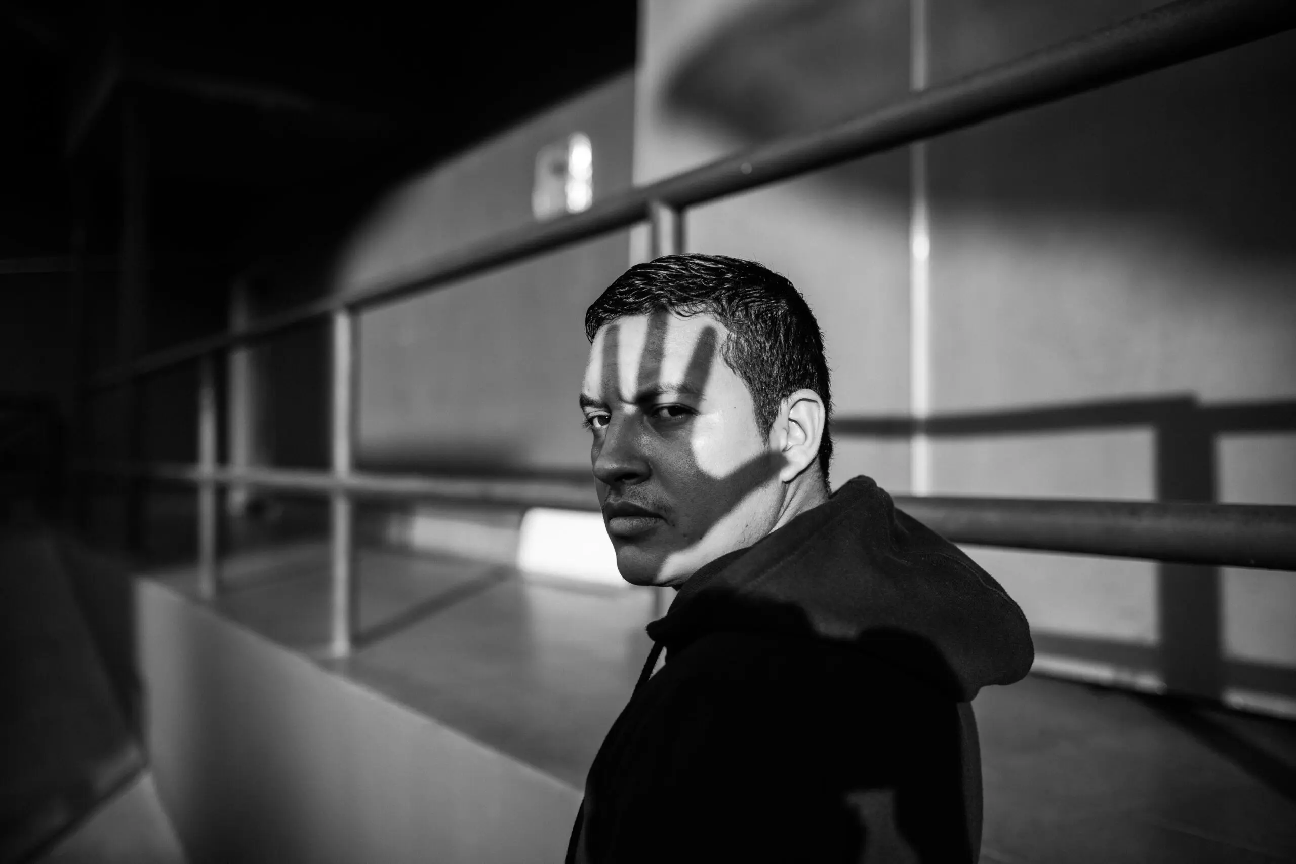 Man-with-a-shadow-of-a-hand-over-his-face-representing-stigma