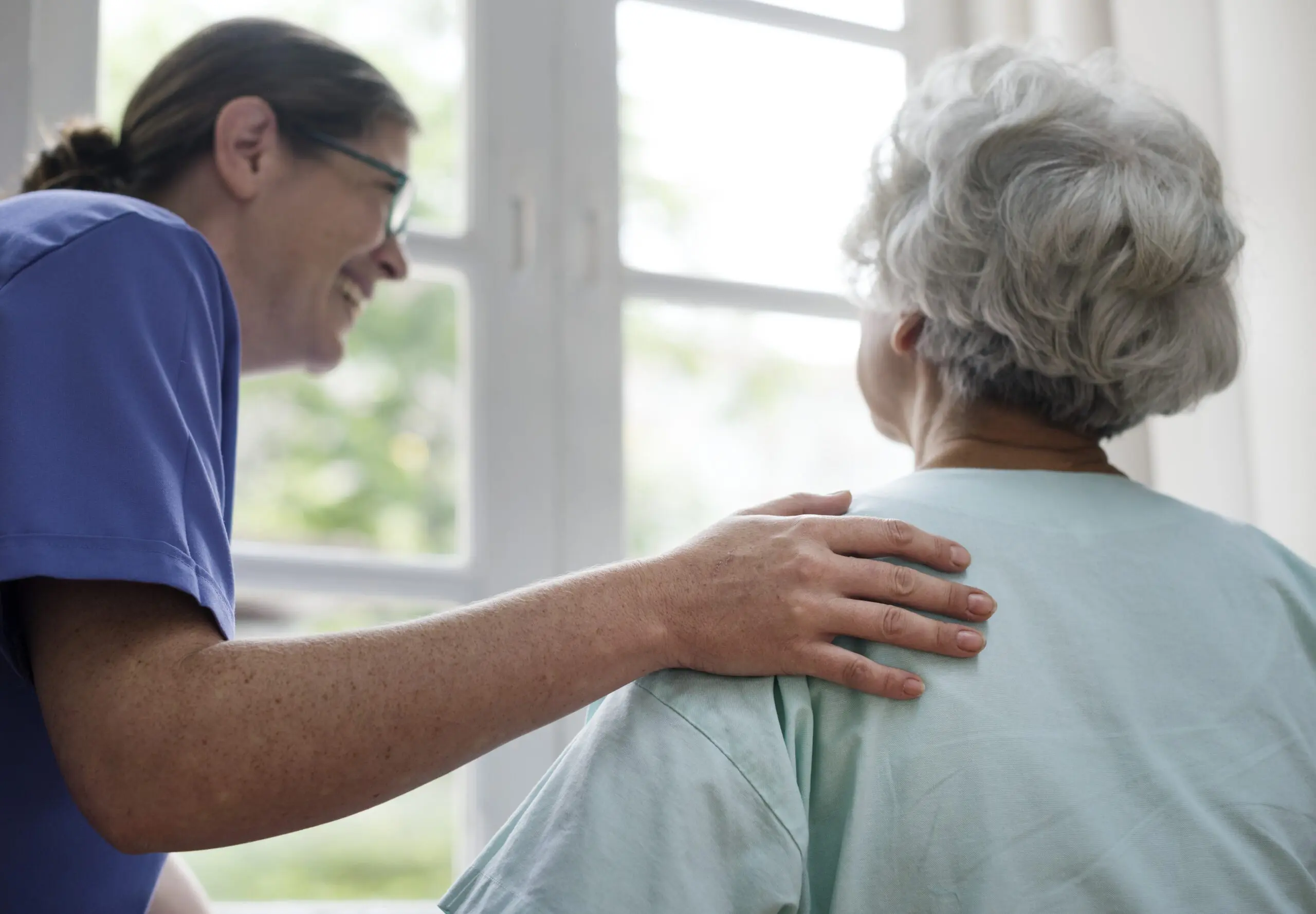 Nurse taking care of an old woman