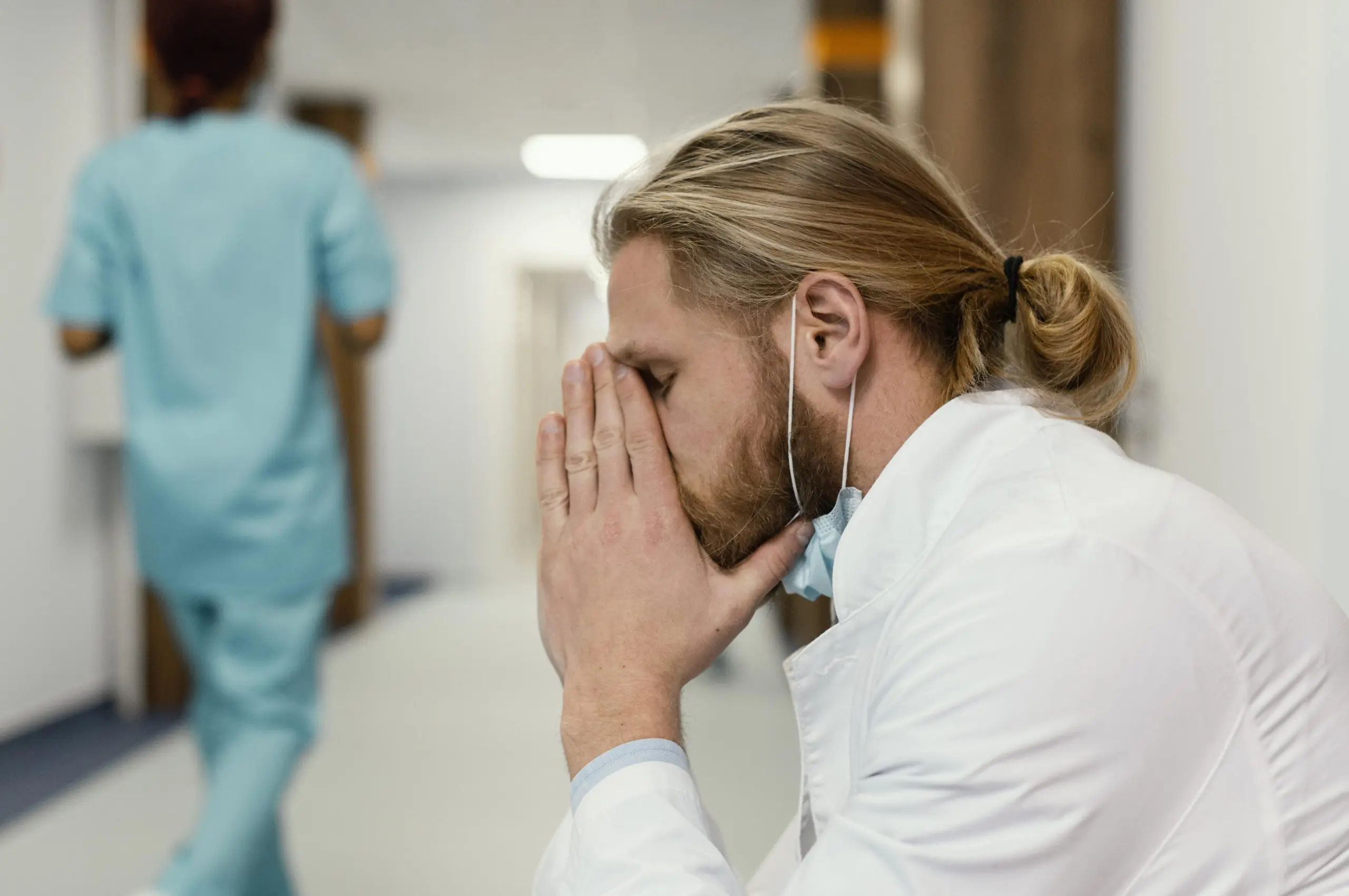 medium-shot-tired-doctor-with-mask