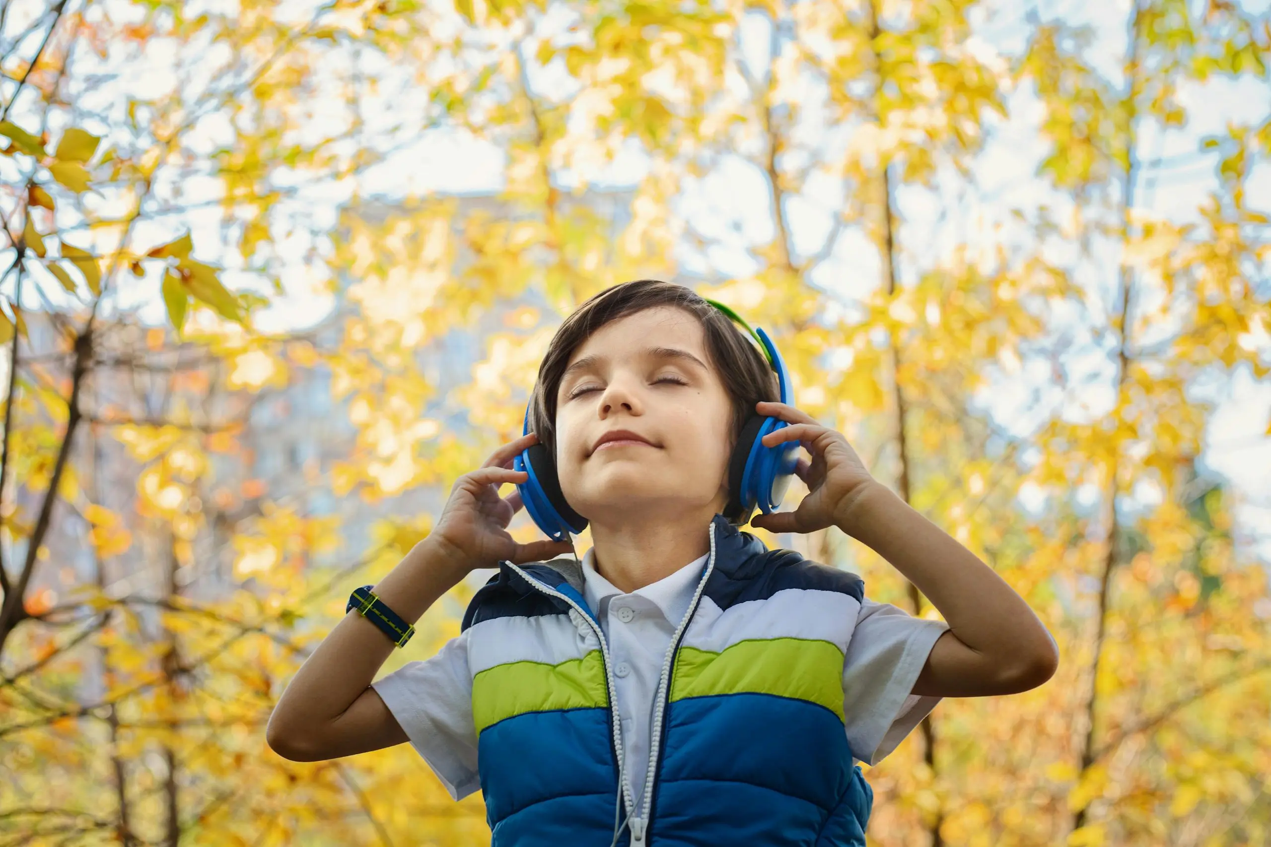 boy-listening-to-music-through-headphones