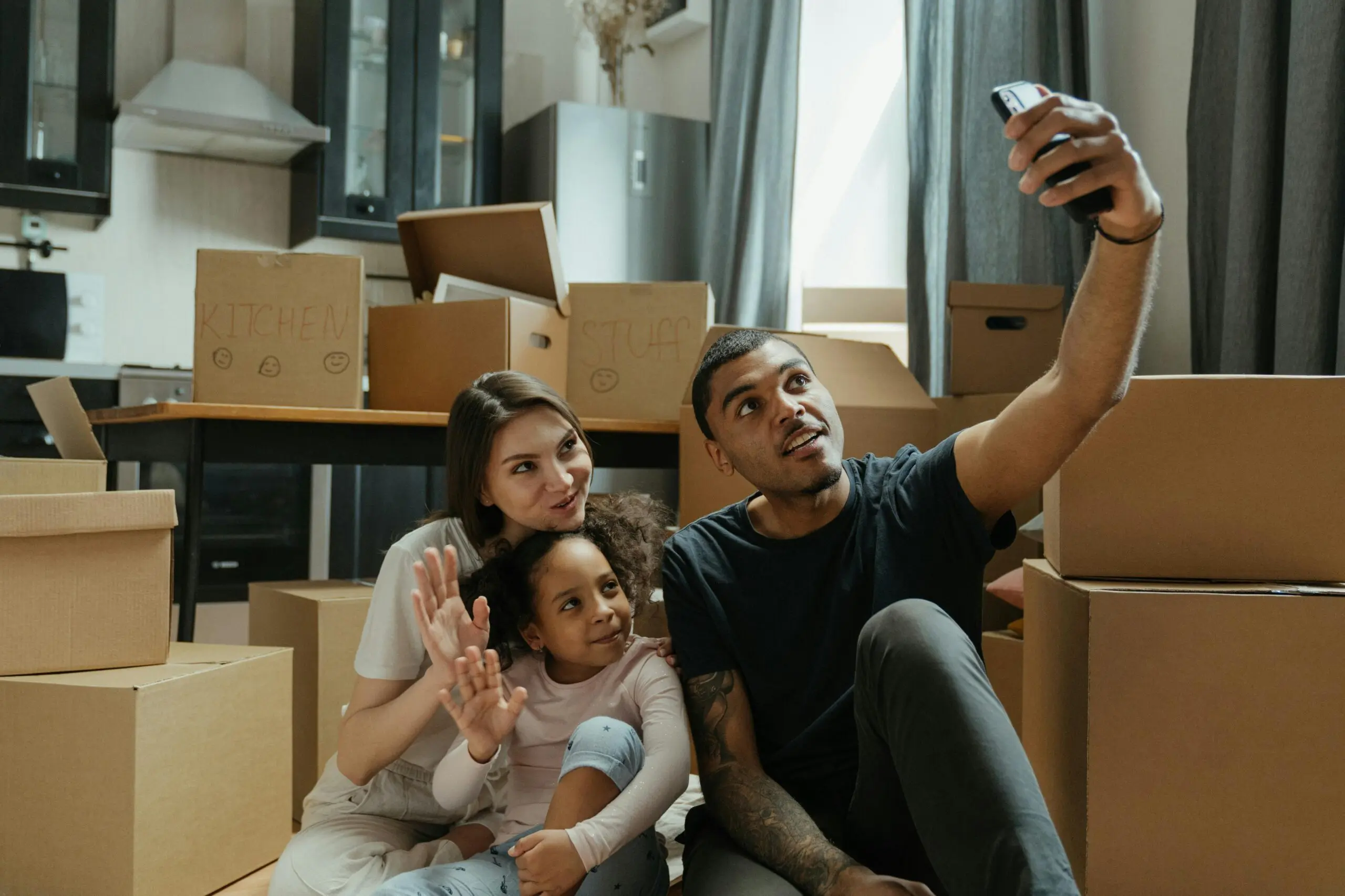 family-surrounded-by-moving-boxes-while-on-a-call