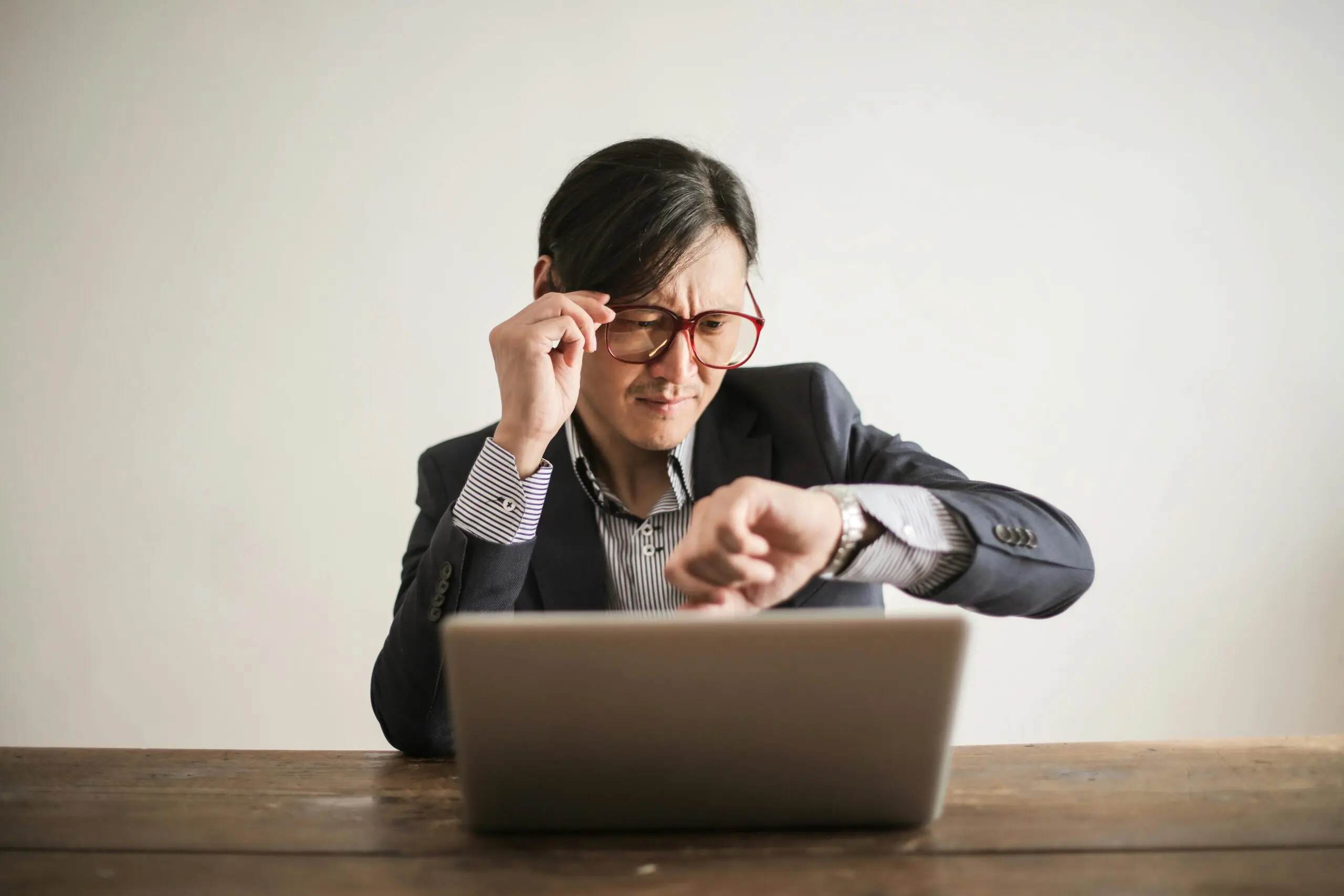 Asian-man-checking-the-time-on-his-watch