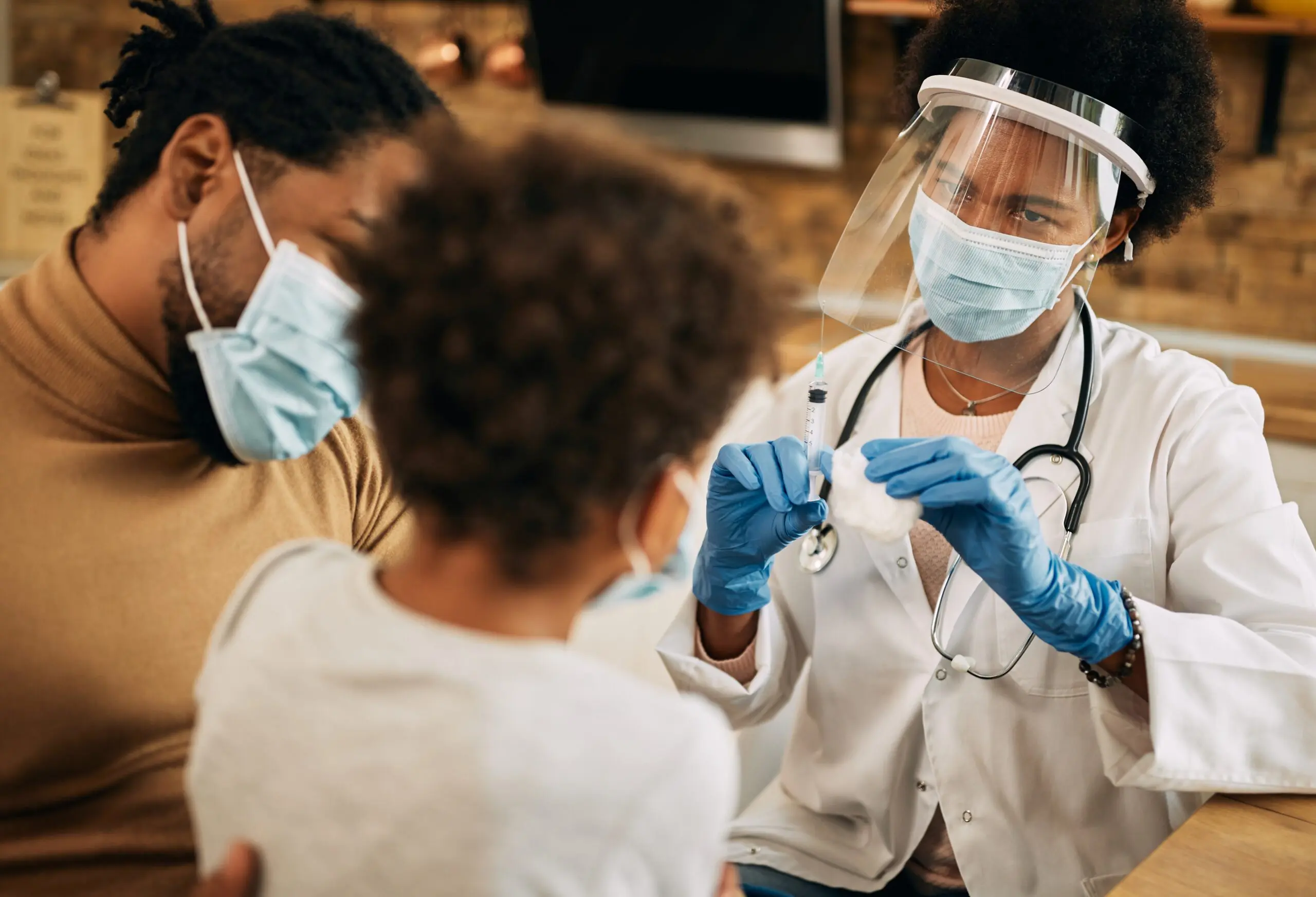 doctor-wearing-PPE-administrating-a-vaccine-to-a-child