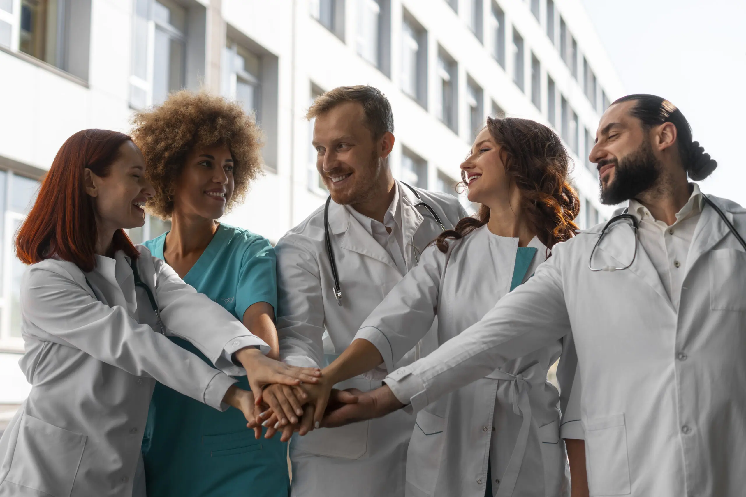 healthcare-team-supporting-one-another-and-putting-hands-in-the-middle