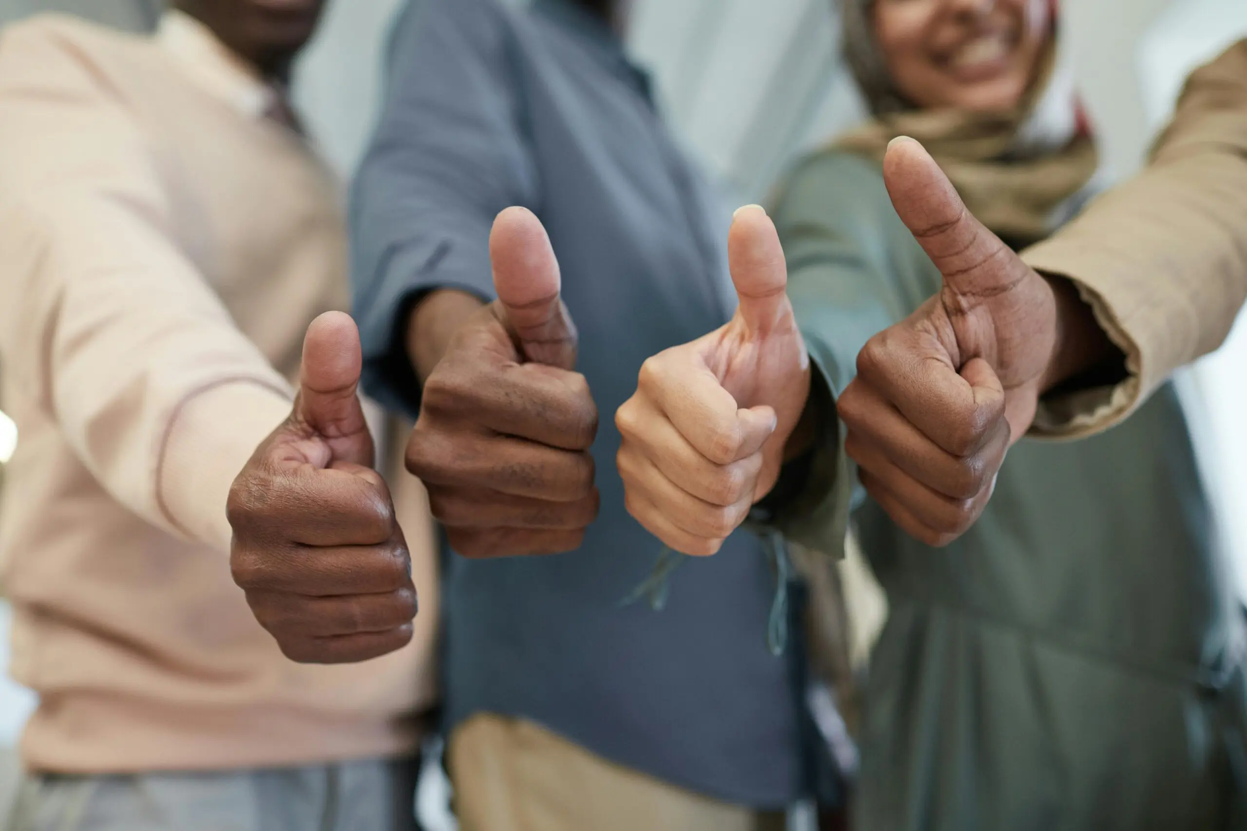 team-members-stood-in-a-line-giving-a-thumbs-up
