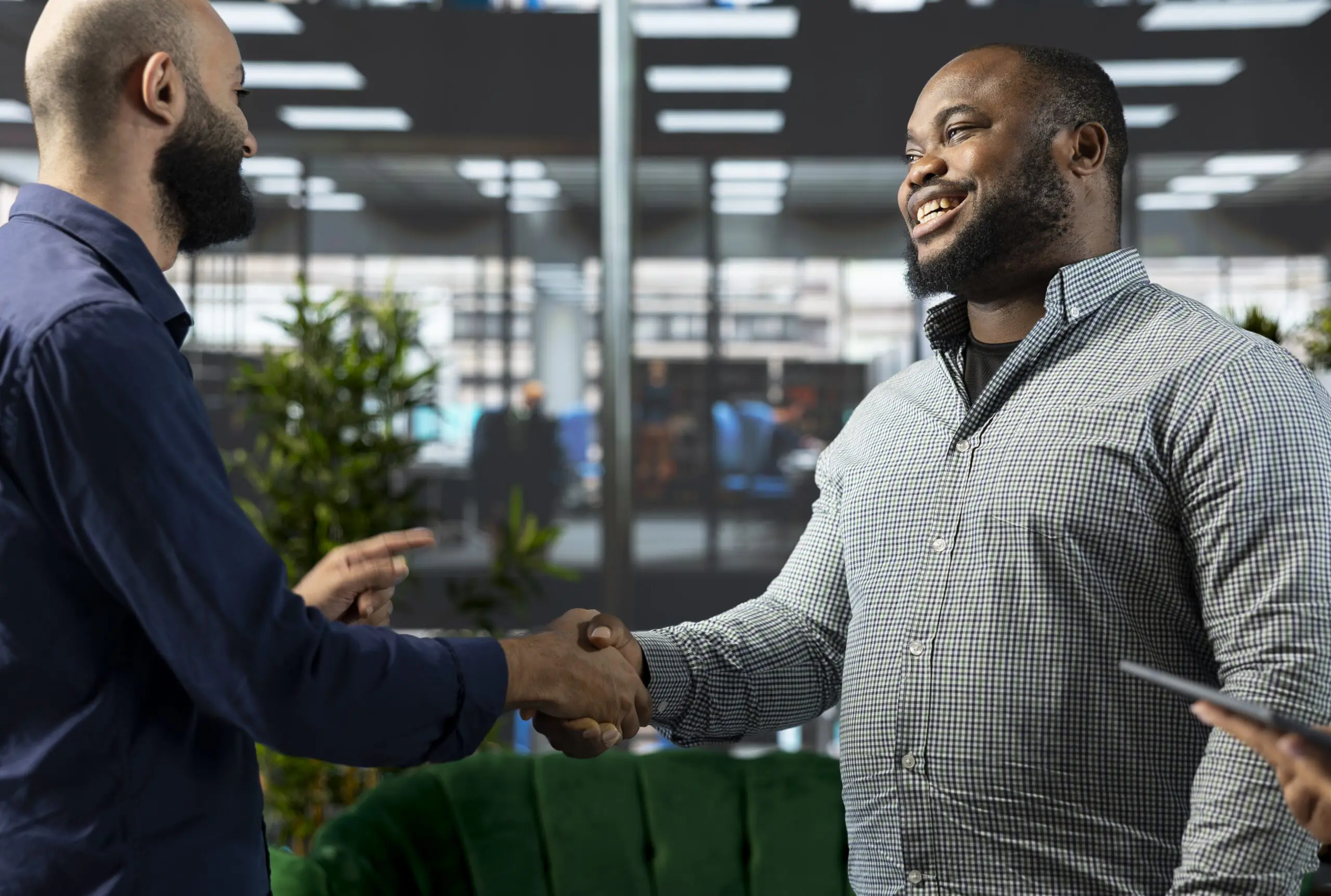 Smiling employee shaking hands with man after interview