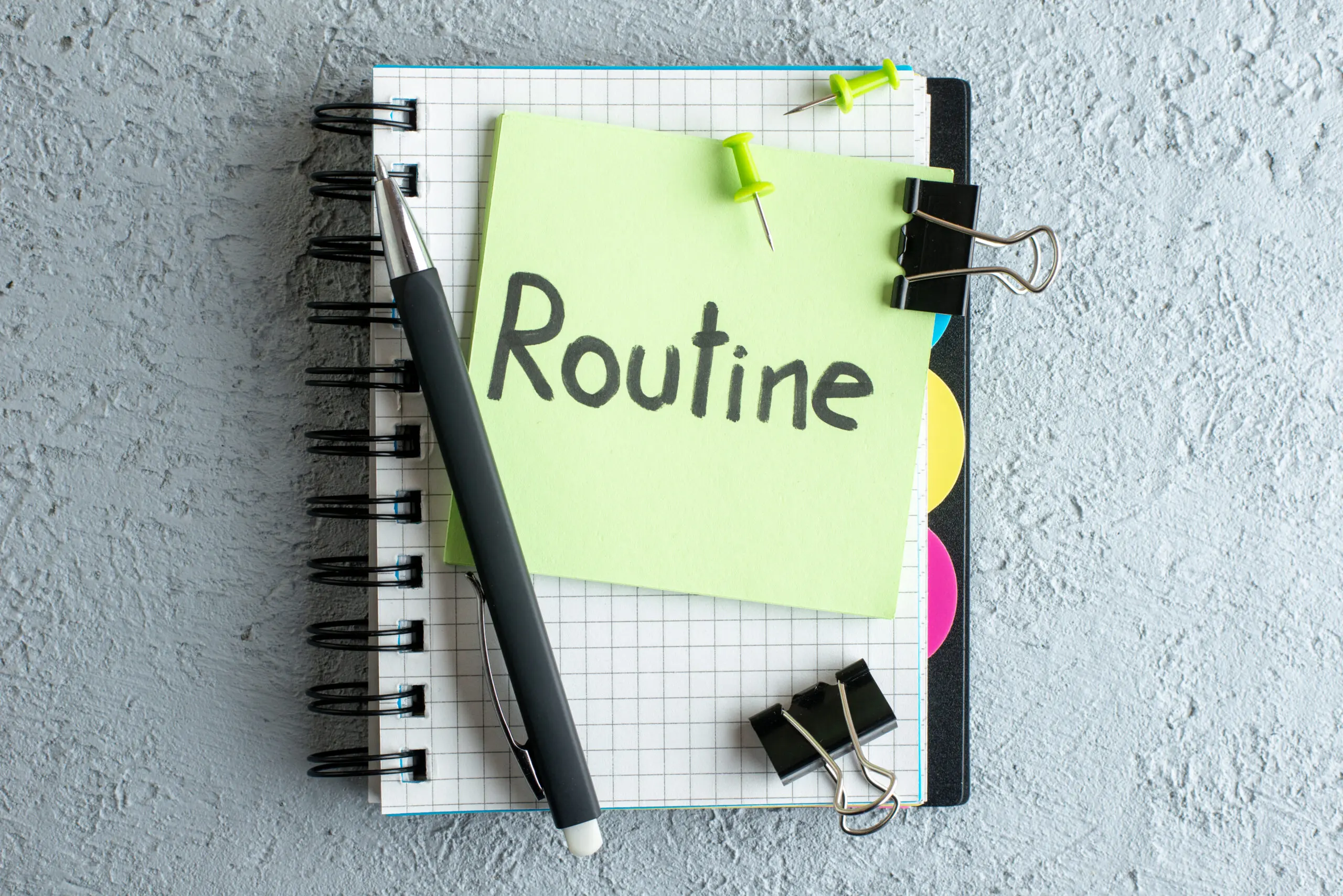 top-view-routine-written-note-green-sticker-with-notepad-pen-white-background-color-job-office-school-copybook-college-business