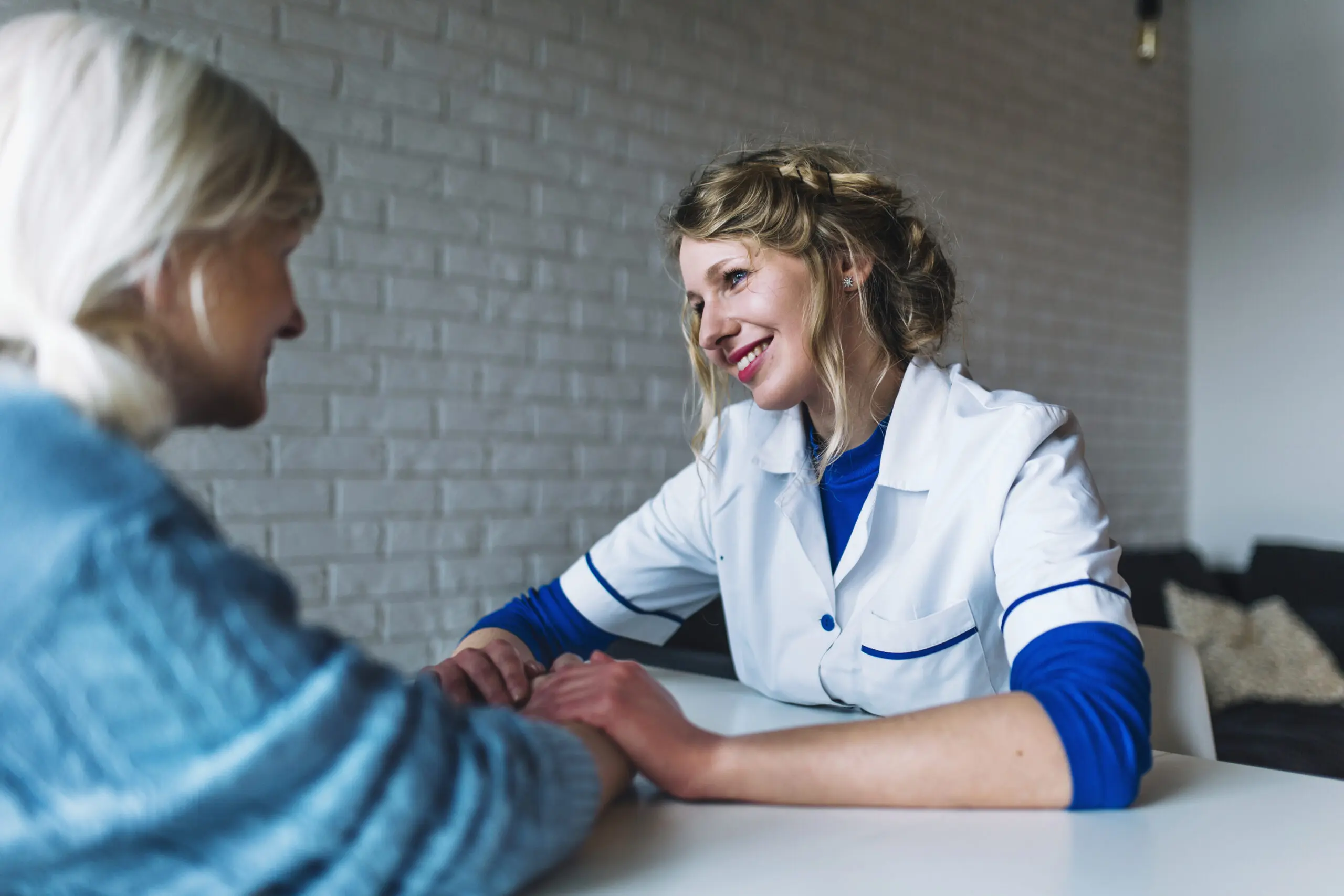 smiling care worker supporting patient confidently due to communication skills