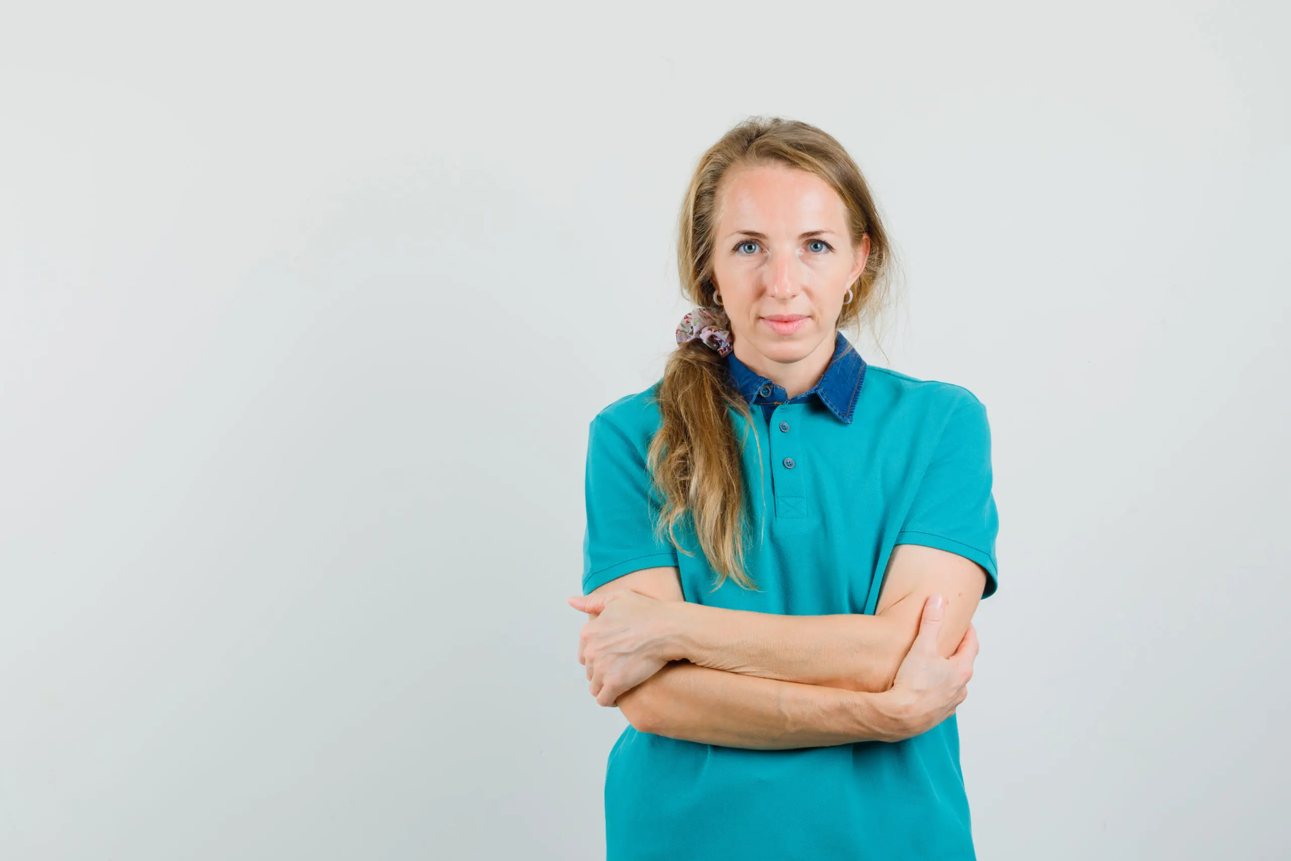 Young woman who has her arms locked together showing discomfort and lack of confidence