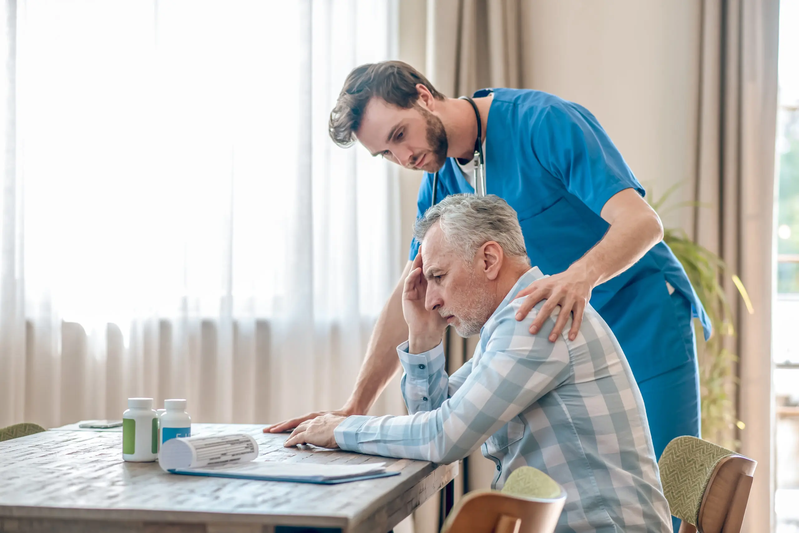 care worker looking after elderly man