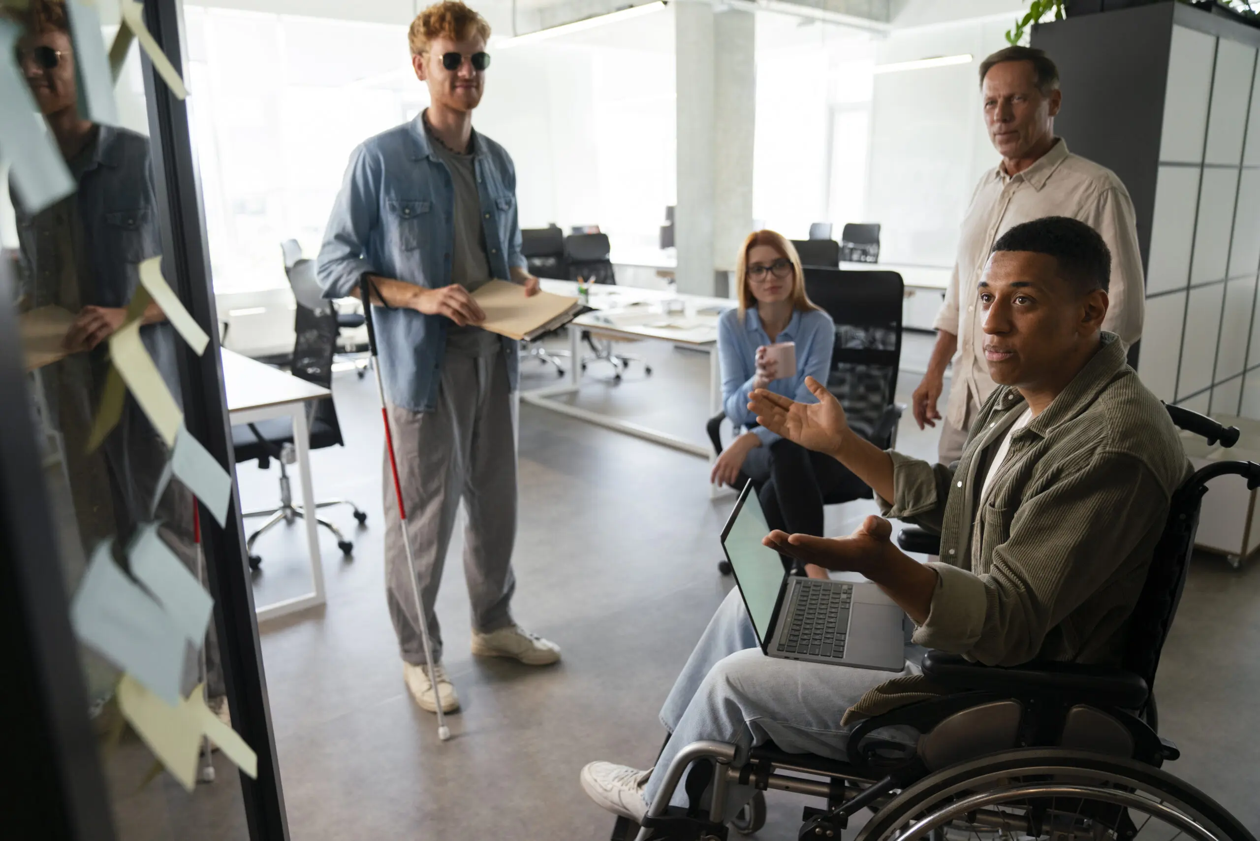 disabled-man-wheelchair-working-his-office-job