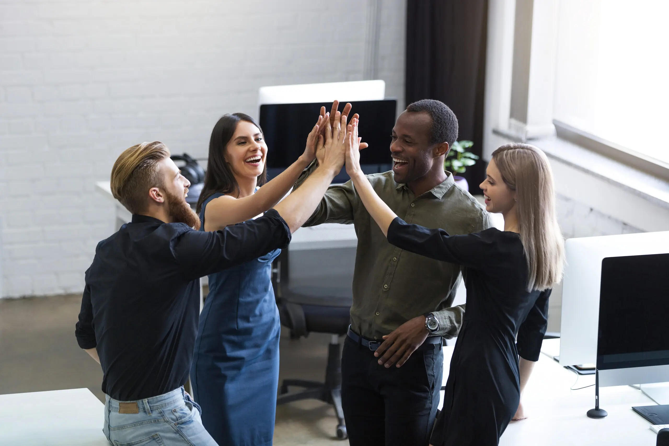 group of young colleagues celebrating their hard work