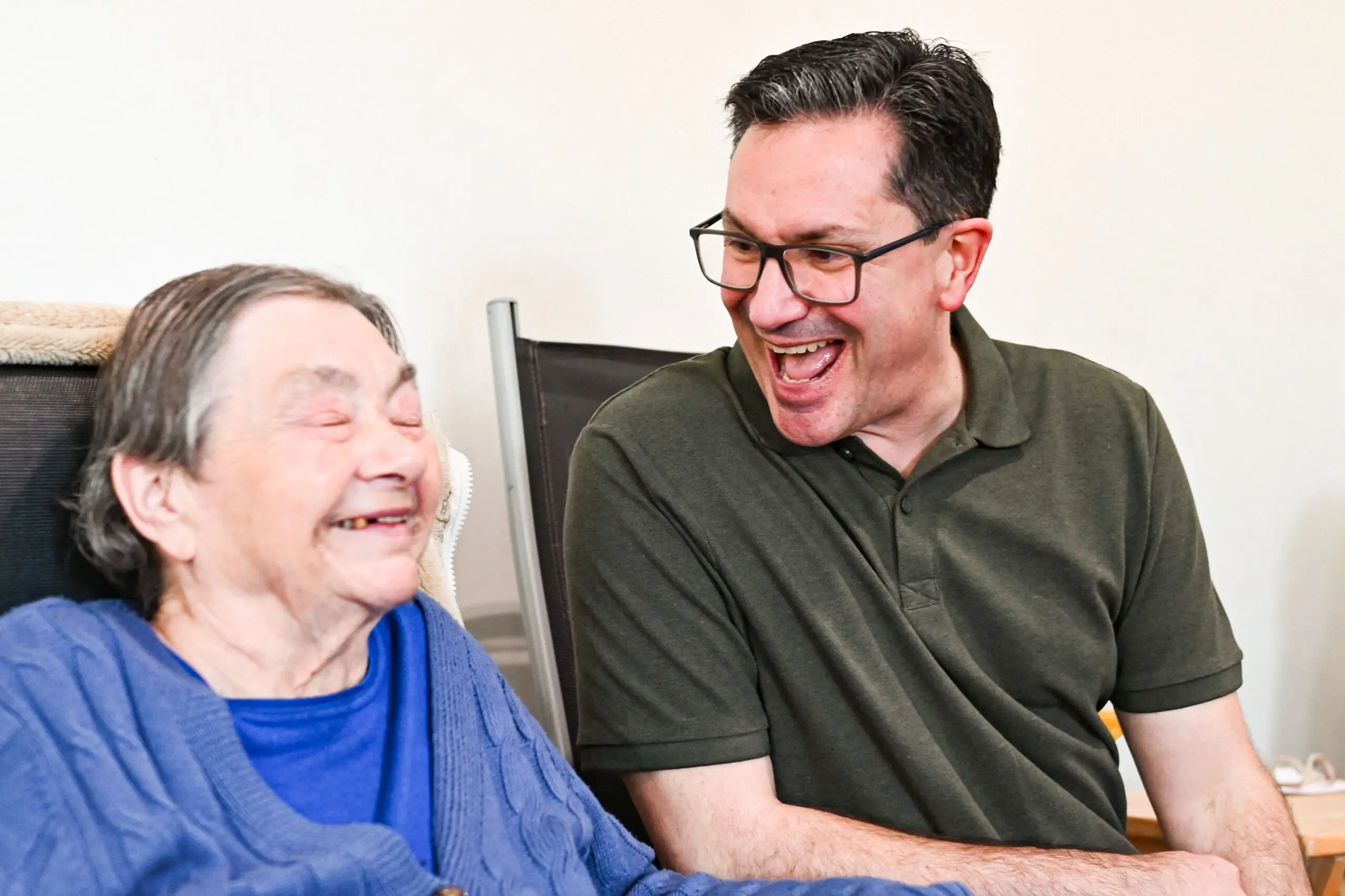 support worker laughing with elderly patient