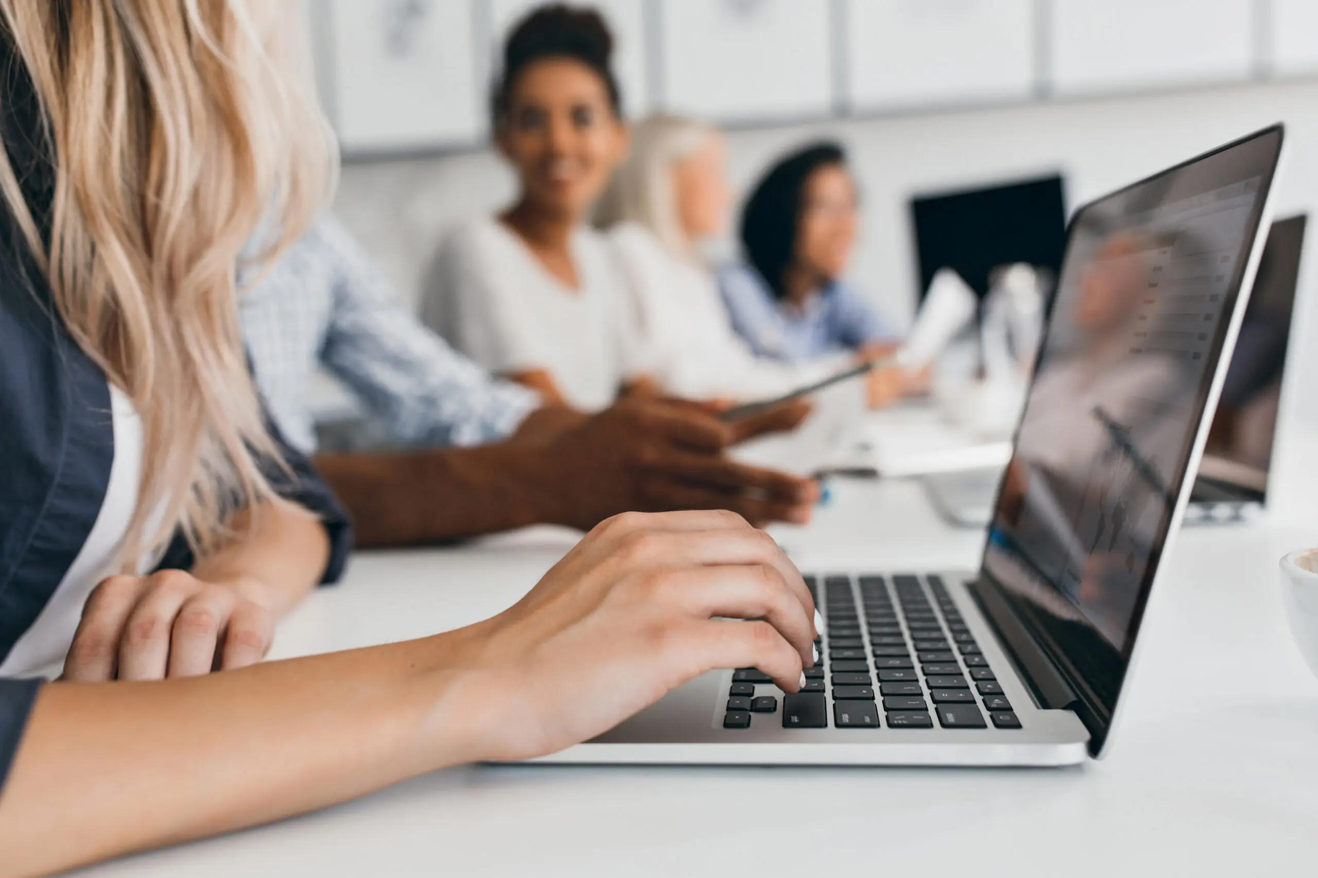 blonde woman using a computer to complete Halo Staffings training courses