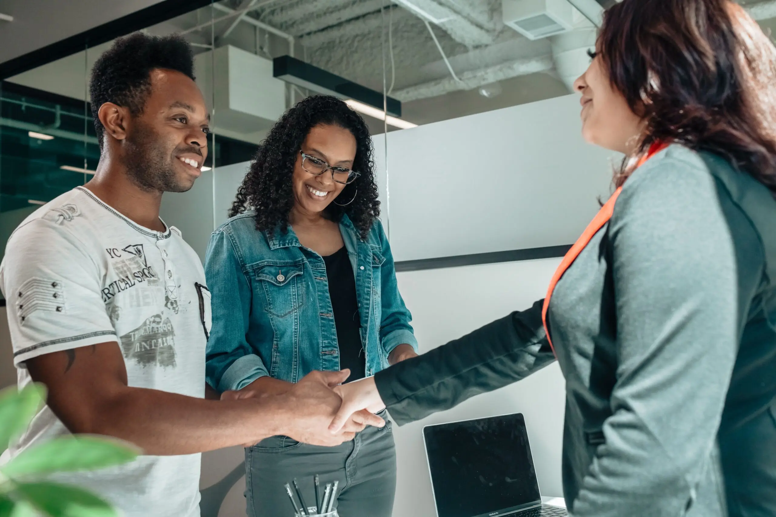 halo staffing worker smiling at and in a handshake with service providers