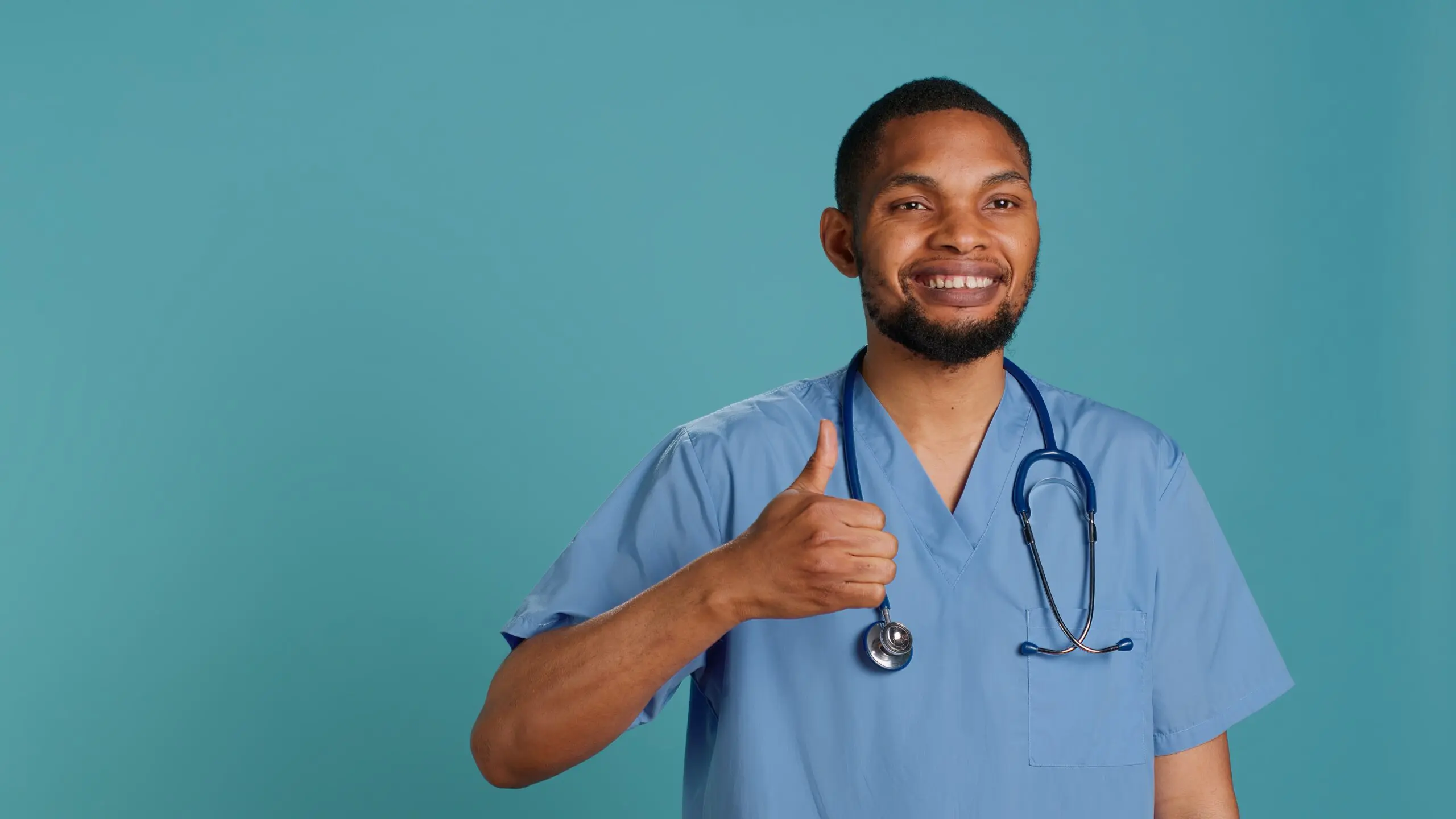 Cheerful male nurse showing thumbs up signs