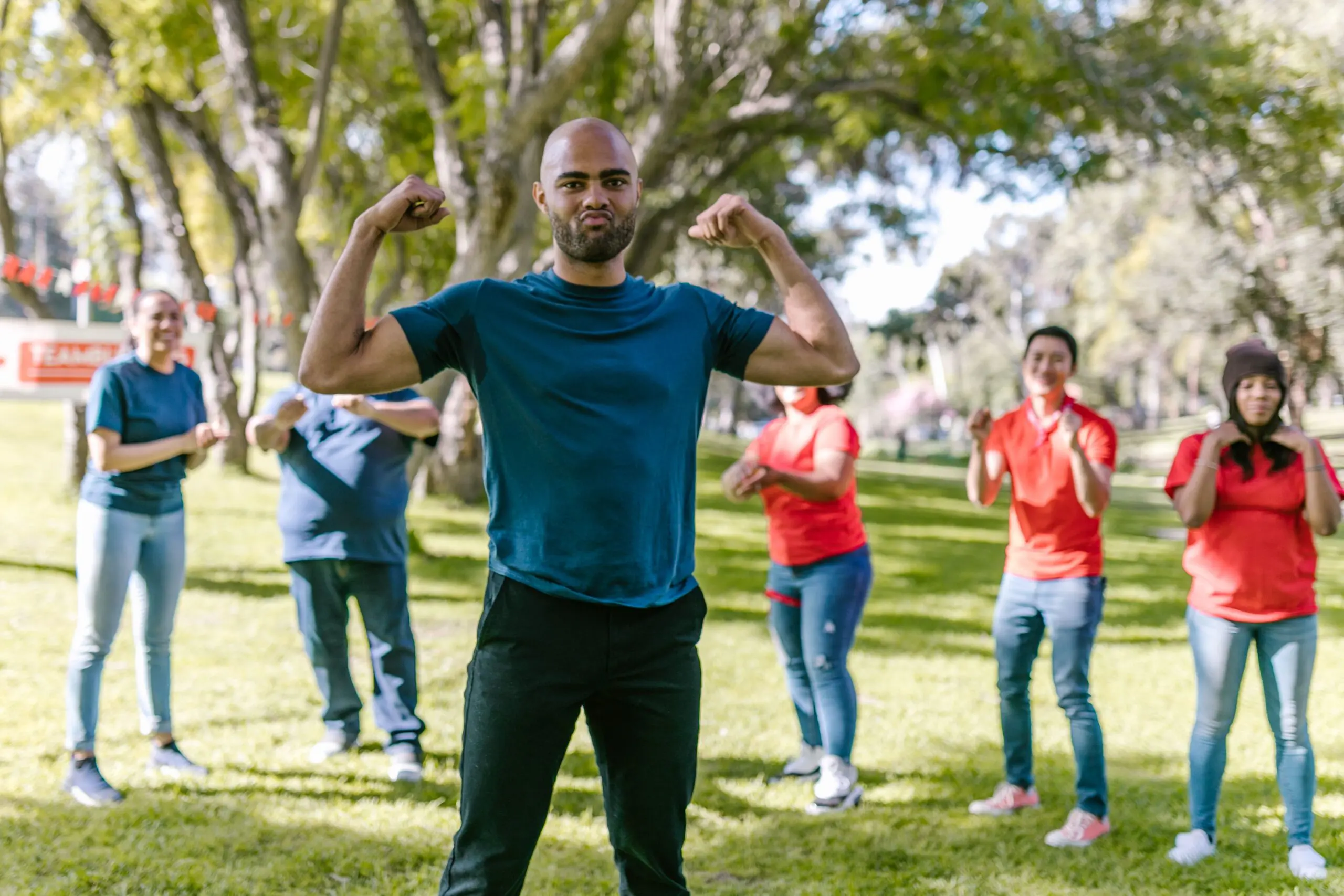 strong care team, man in middle flexing his muscles