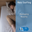 A woman fully clothed lying in bed looking sad. Overlaid are the words 'Halo Staffing, Managing Anxiety' and underneath is a Skills For Care Endorsed Provider logo